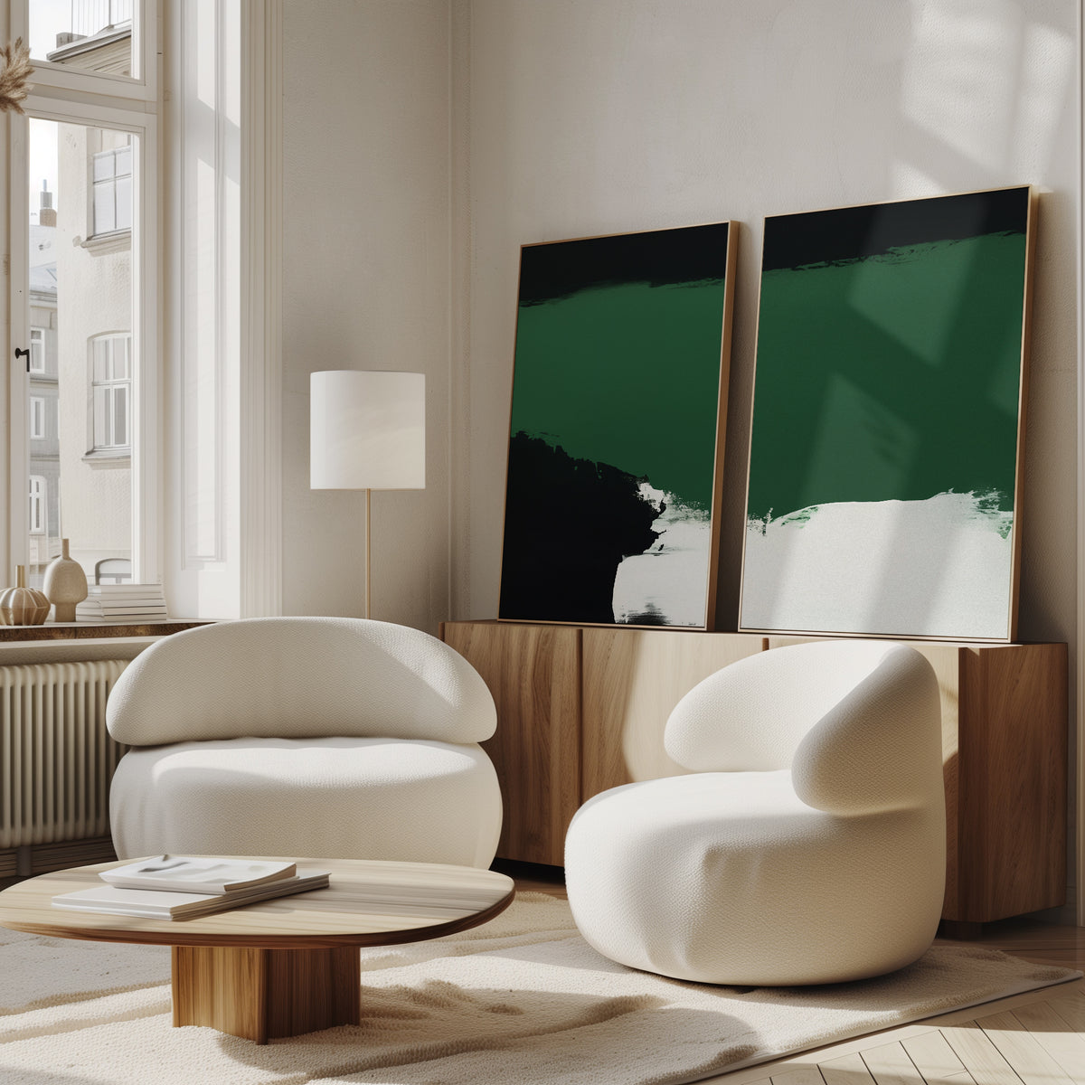 A modern living room with two rounded white chairs, a low wooden coffee table, a floor lamp, and Jade Depths - Set Of 2 wall art on a wooden sideboard near large windows.