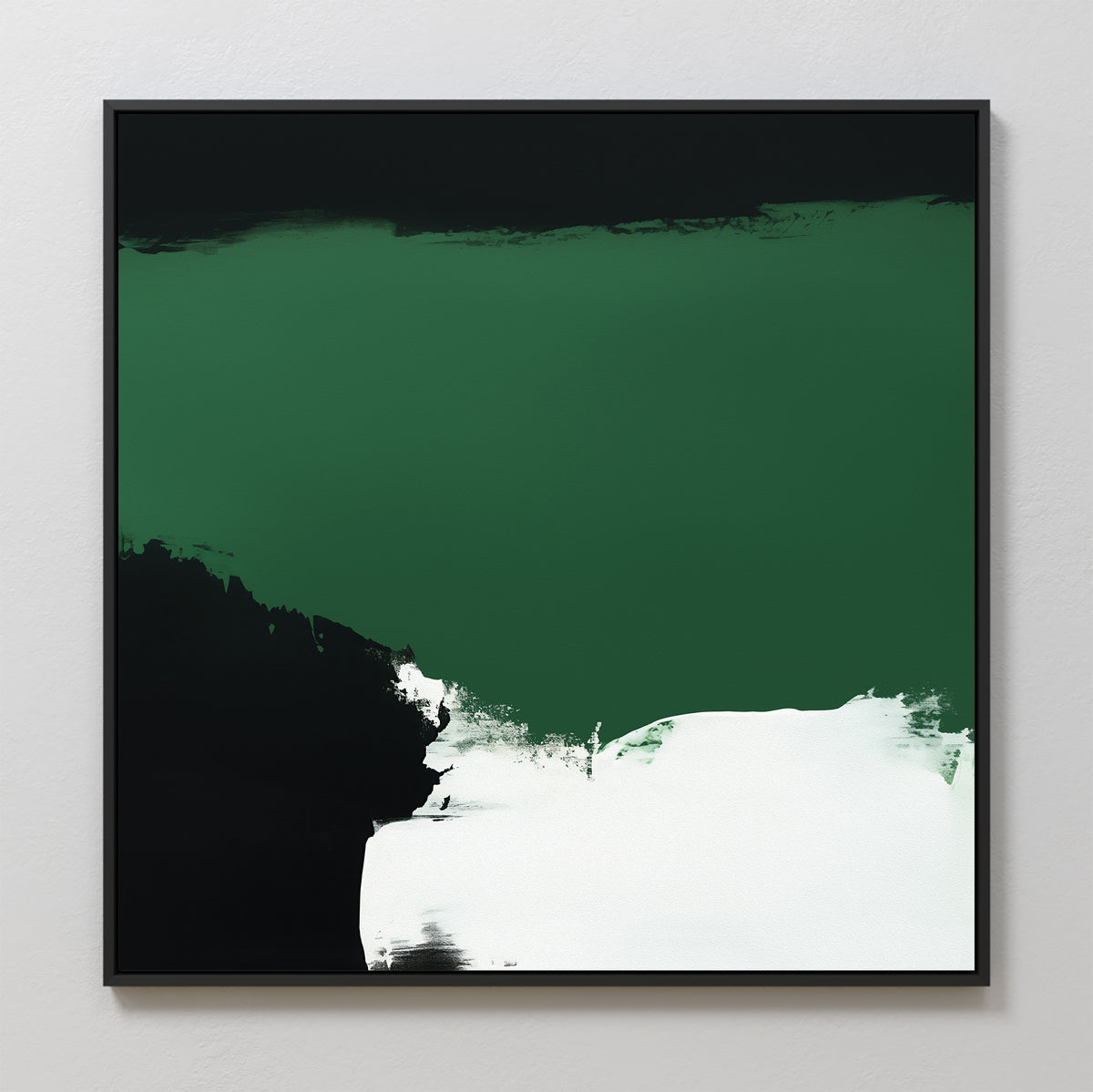 The Jade Depths Canvas Art - Square features a bold emerald green top section, a black area on the left, and white brushstrokes at the bottom. This contemporary print comes in a slim black frame and is displayed against a light gray wall.