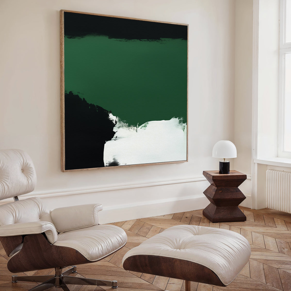 A modern living room featuring a white leather lounge chair and ottoman, a dark wood side table with a small white lamp, and the Jade Depths Canvas Art - Square bringing striking style to the space’s decor.