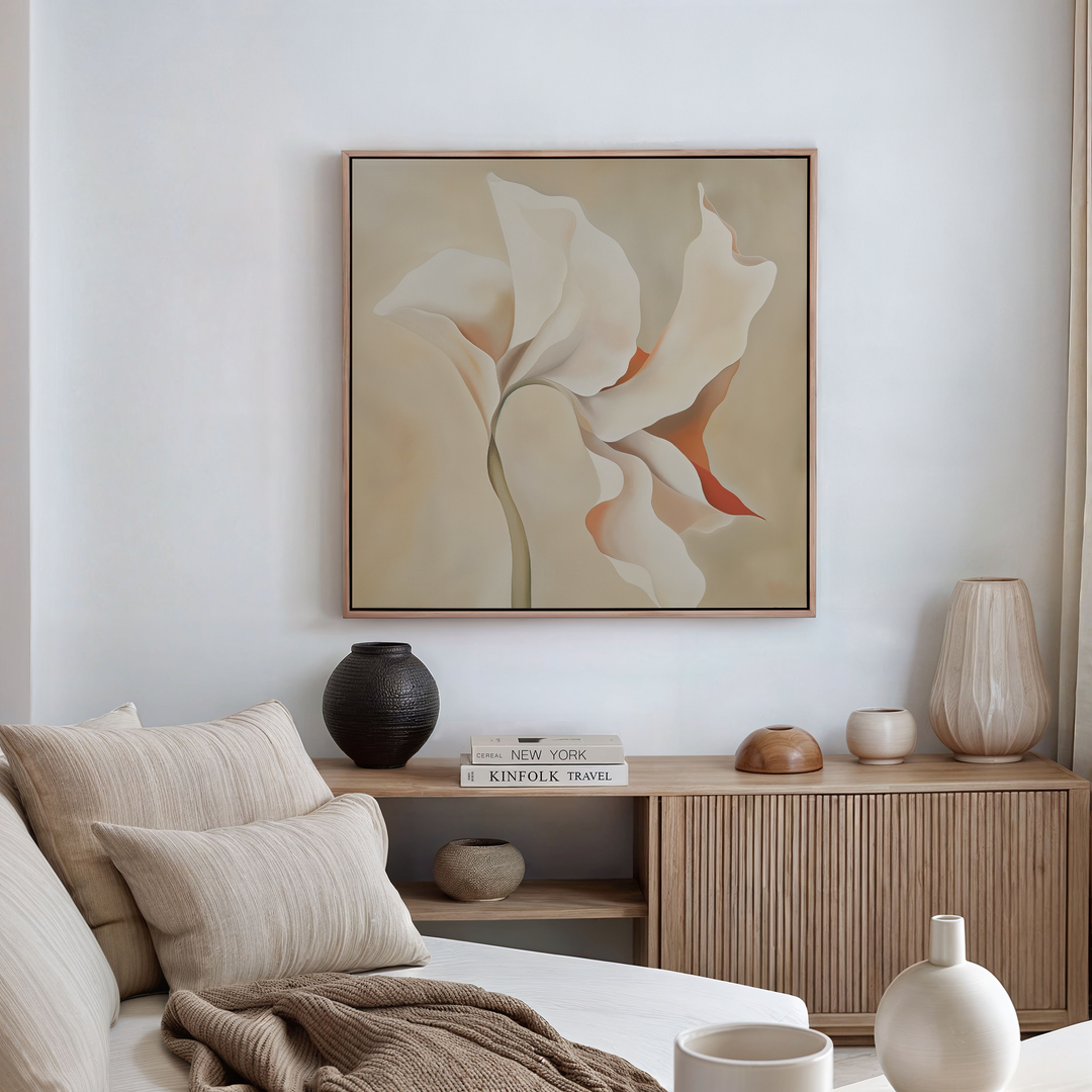 A minimalist living room with a neutral palette features a beige sofa, a wooden sideboard with vases and books, and the Delicate Bloom Abstract Canvas Art above the sideboard—perfect for stylish living room decor.