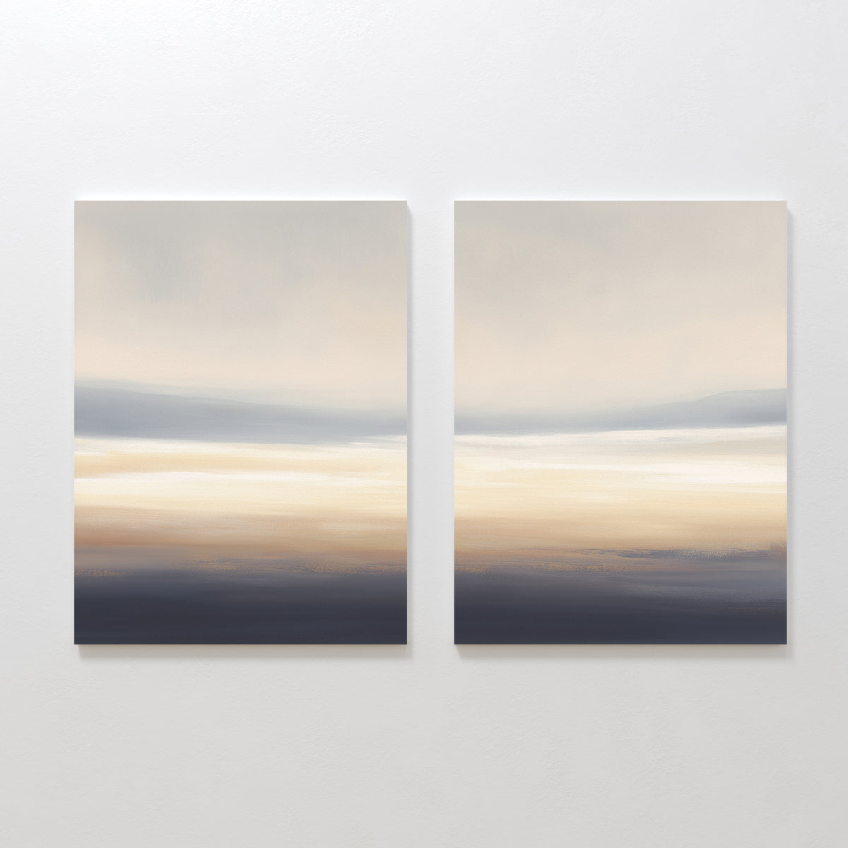The Layered Dusk - Set Of 2 features abstract wall art with soft horizontal streaks in beige, cream, gray, and dark blue—evoking a serene horizon and perfect as calming prints for a Nordic Park-inspired space.