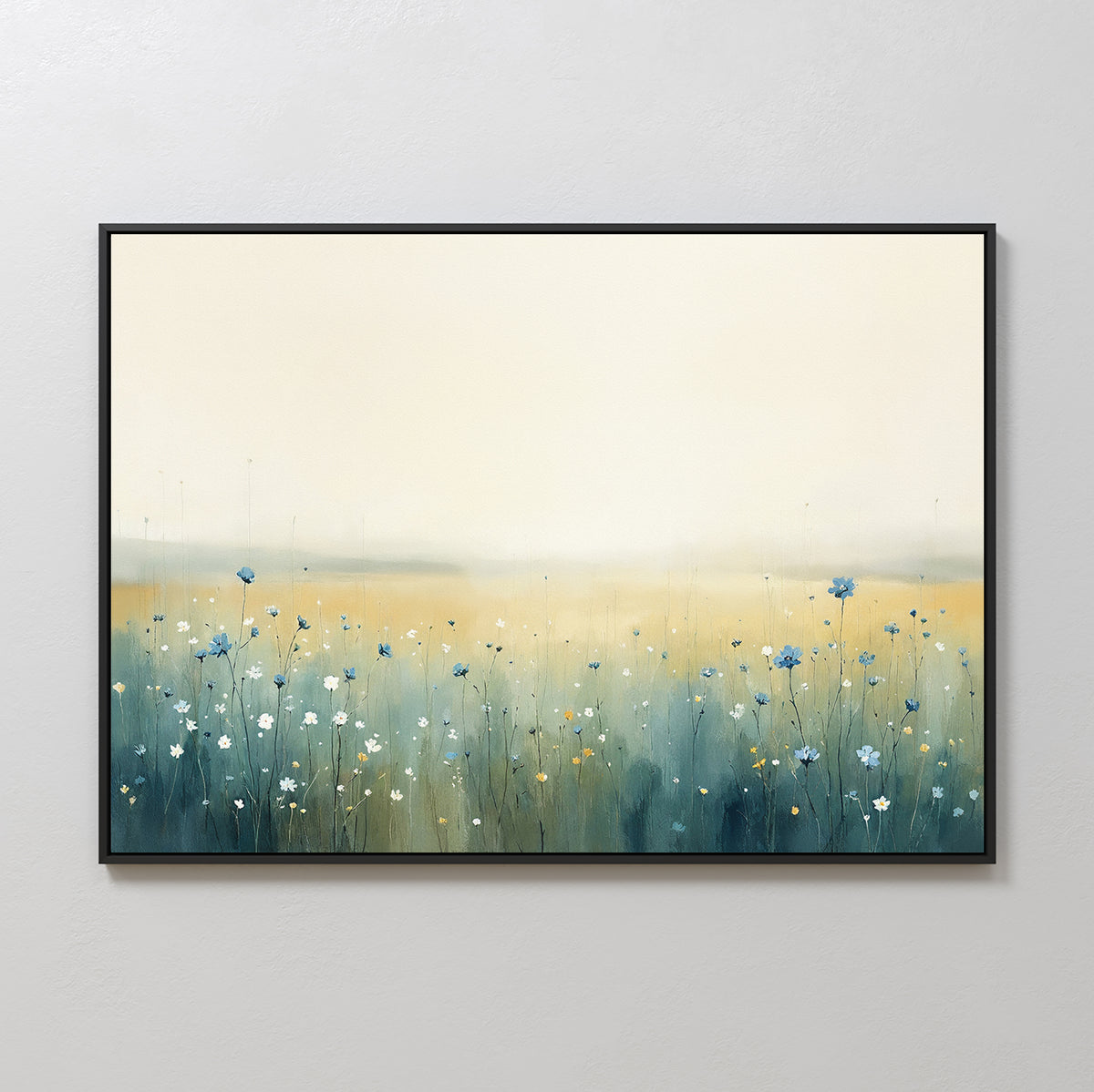 The Meadow Whispers Canvas Art - Horizontal features a serene impressionistic landscape with blue and white wildflowers and a hazy golden sky, elegantly framed and displayed on a light-colored wall.