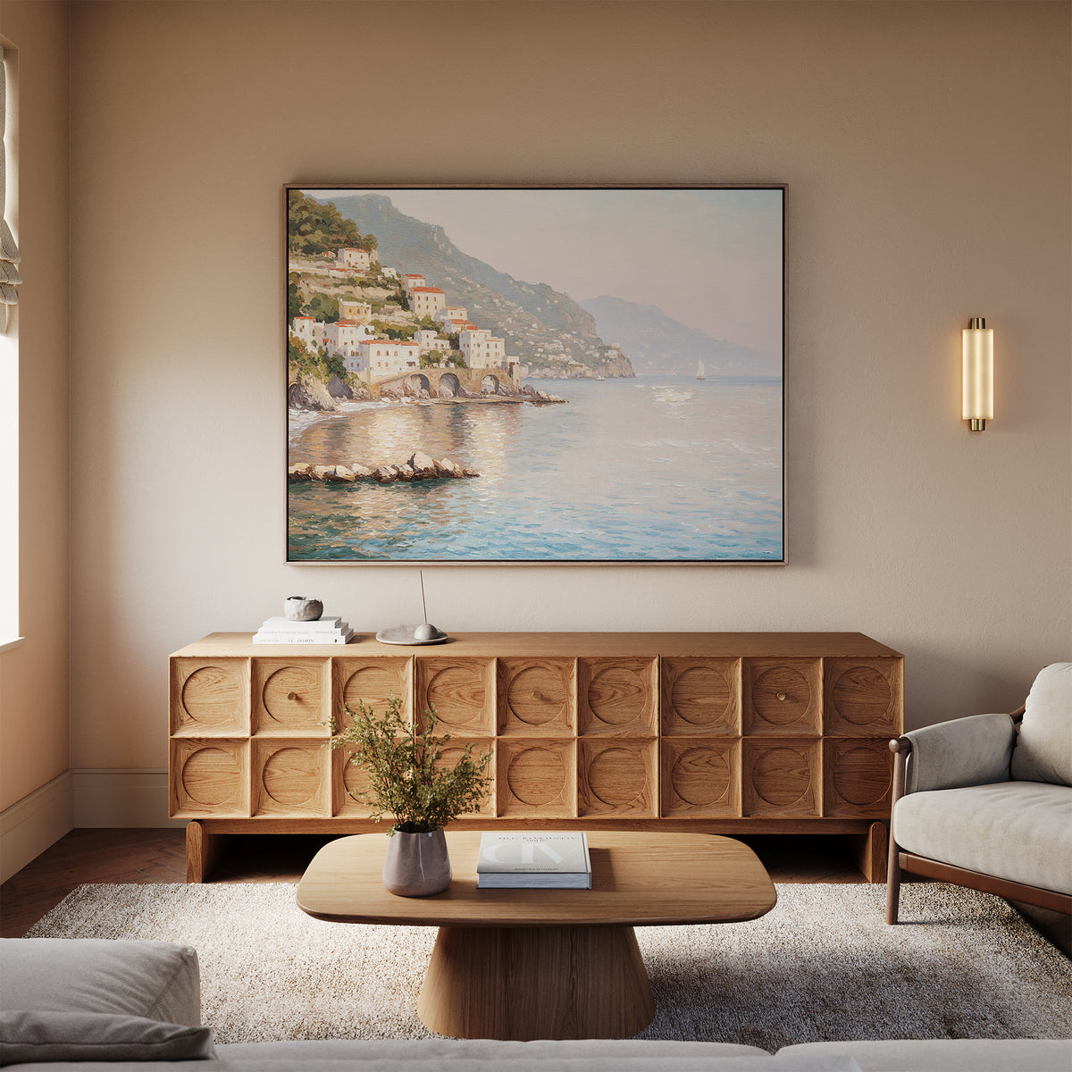 A cozy living room features a wooden sideboard, light wood coffee table, beige sofa, and the Mediterranean Dreams Canvas Art - Horizontal above the sideboard; a vase of flowers on the coffee table completes the serene decor.