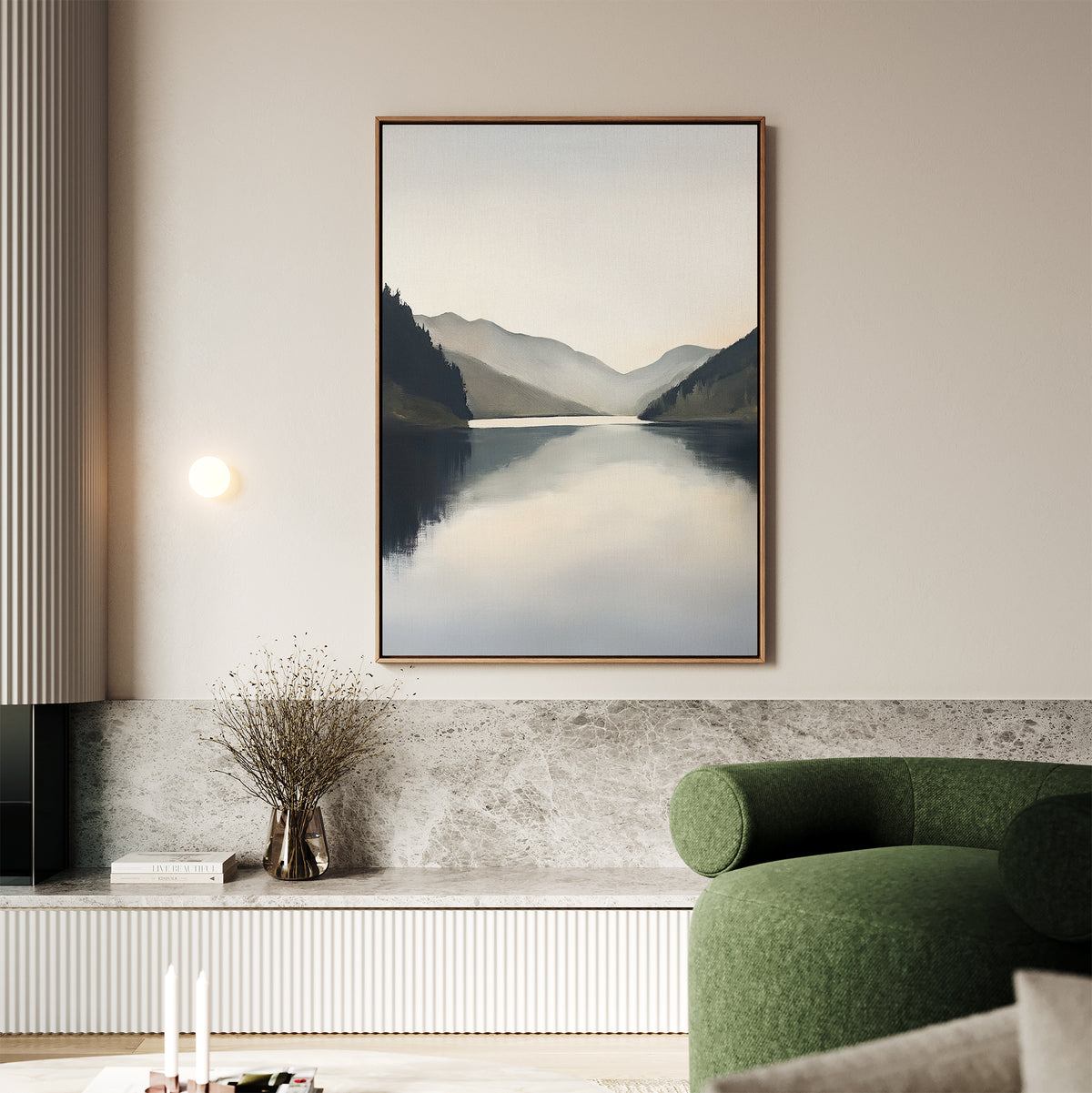 A minimalist living room features the Mirror Valley Canvas Art - Vertical. A round green sofa, marble surfaces, a small vase with dried branches, and a wall sconce complete the modern Nordic decor.