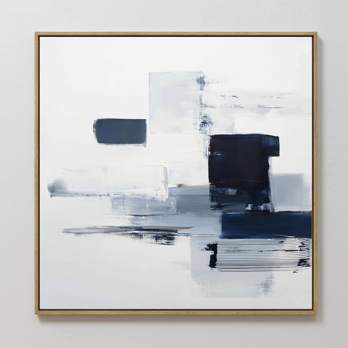 The Navy Brushwork Canvas Art - Square features geometric blue, gray, and white brushstrokes in a gold frame. This minimalist wall art adds a modern, airy touch—perfect for anyone who loves contemporary home decor.
