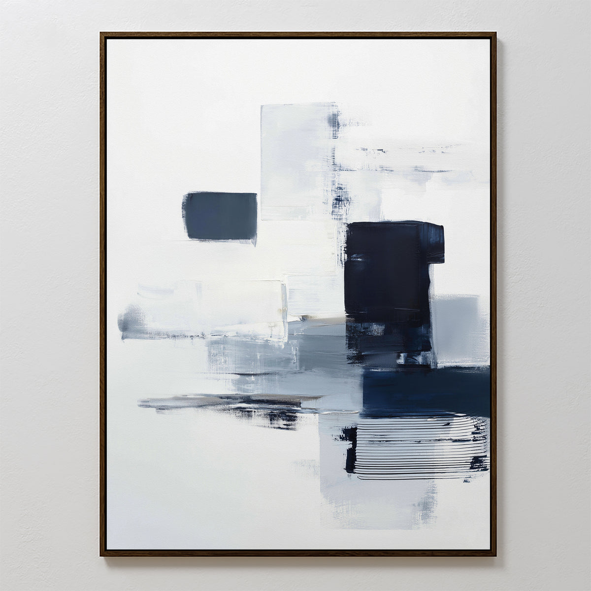 The Navy Brushwork Canvas Art - Vertical showcases abstract brushstrokes and blocks of navy, gray, and black on a white background. Framed with a thin, dark border, it's perfect for modern, minimalist home decor.
