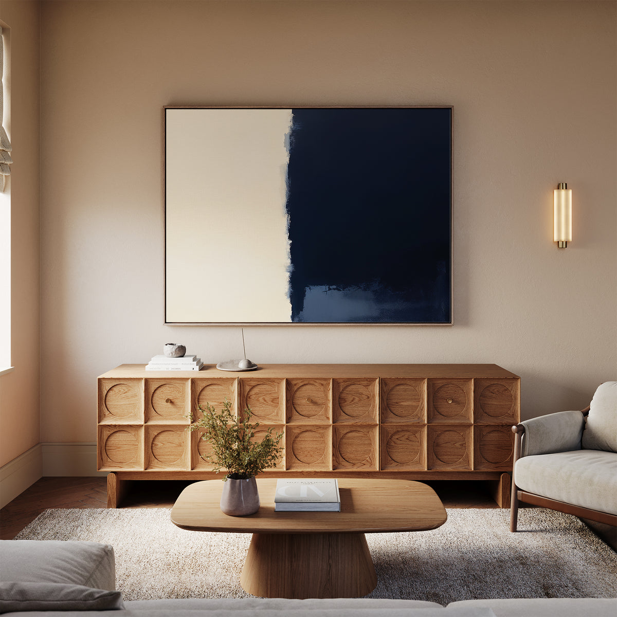A modern living room with a wooden sideboard, Navy Division Canvas Art - Horizontal above it, a beige sofa, a wooden coffee table with books, a light rug, and a wall sconce on neutral walls radiates modern elegance.