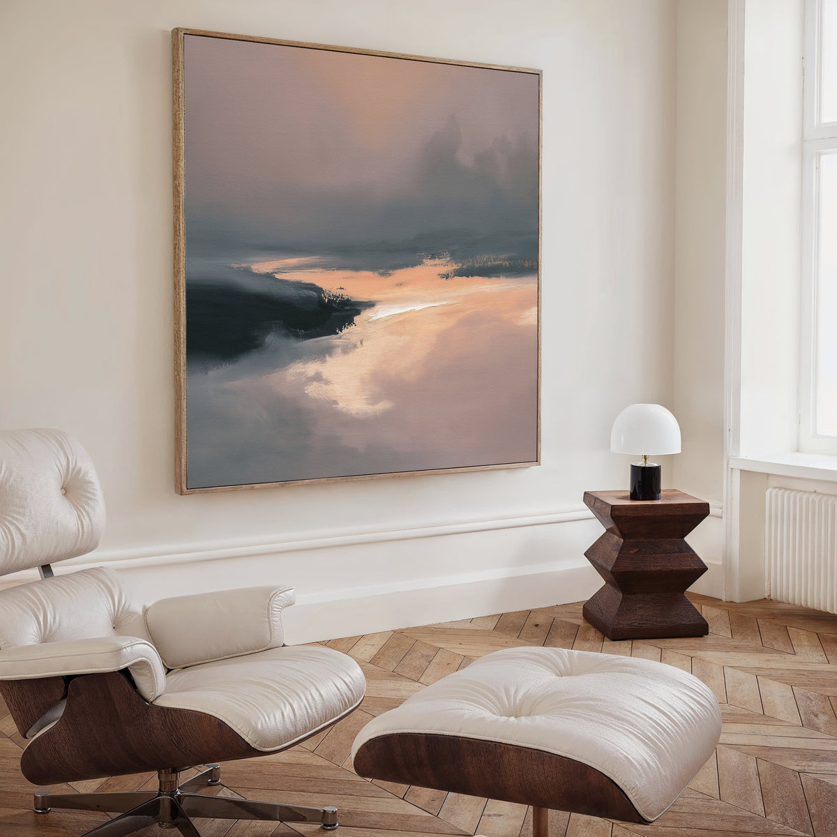 A modern living room with a white leather lounge chair and ottoman, wooden side table with a white lamp, and the Nordic Fjord Canvas Art - Square as calming abstract wall art to enhance the serene vibe of the space.