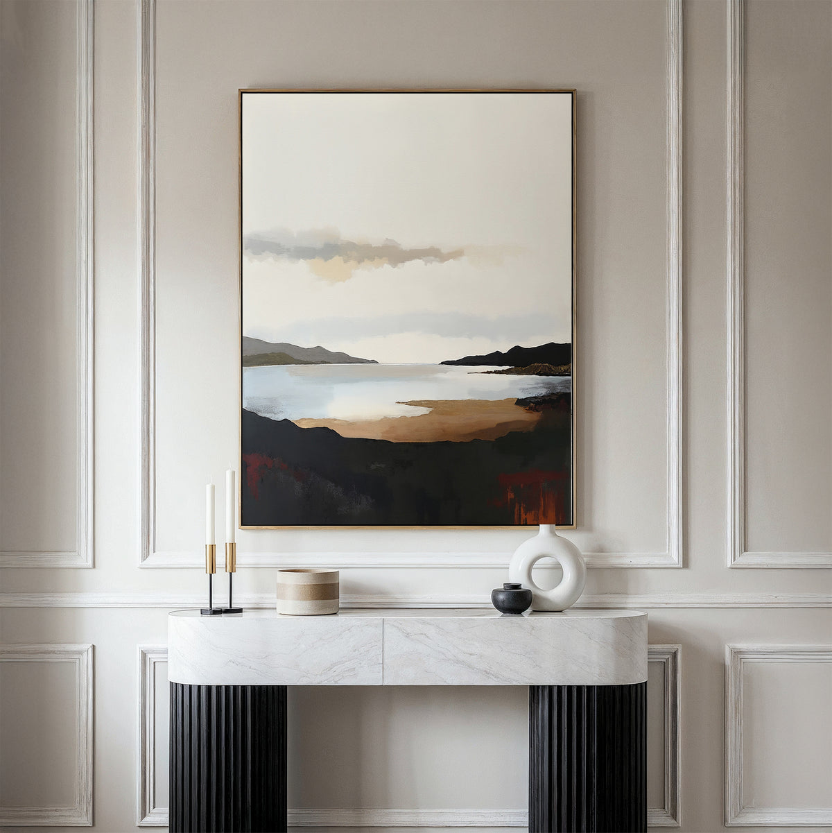 A minimalist room features the Nordic Waters Canvas Art - Vertical, showcasing a serene lake and mountains above a marble console table adorned with modern candles and vases for a sophisticated touch.