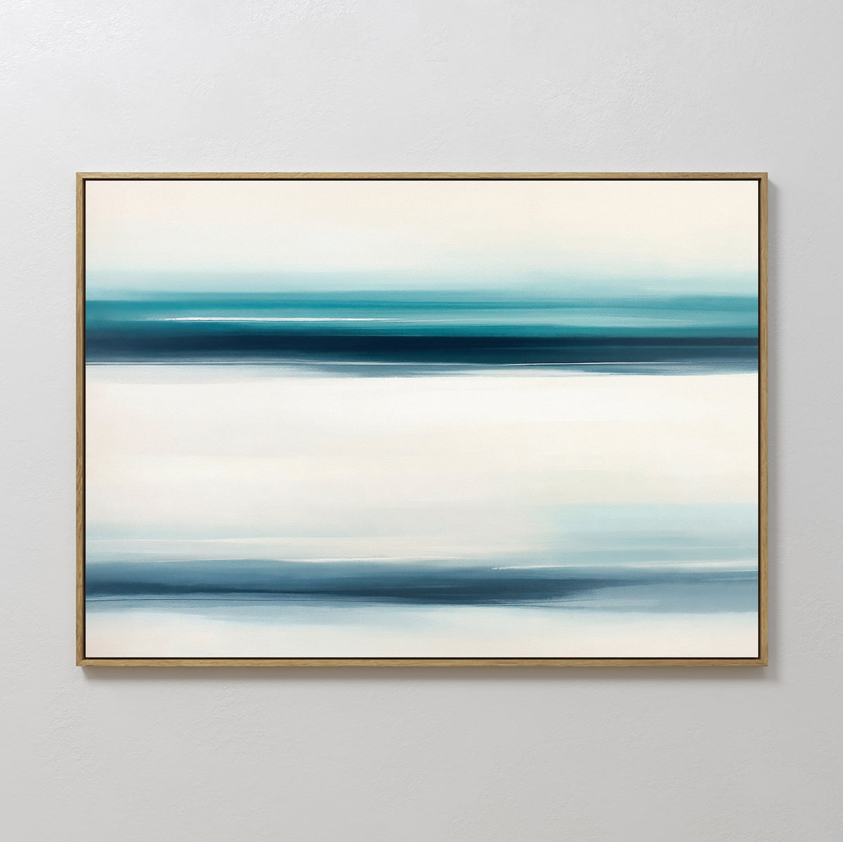Ocean Motion Canvas Art - Horizontal features softly blended blue, teal, and white bands for a serene coastal feel. Displayed in a thin gold frame on a light wall, it brings sophisticated tranquility to any space.