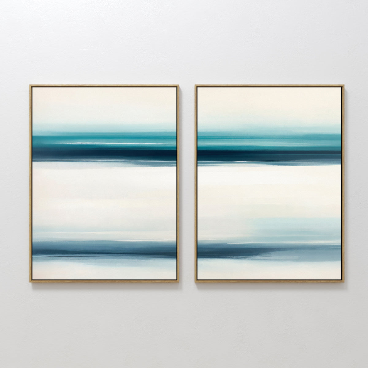 The Ocean Motion - Set Of 2 features two framed abstract prints with blue, teal, and white bands that evoke a calm, watery vibe. Hung side by side, they bring serene sophistication—ideal for coastal decor lovers.