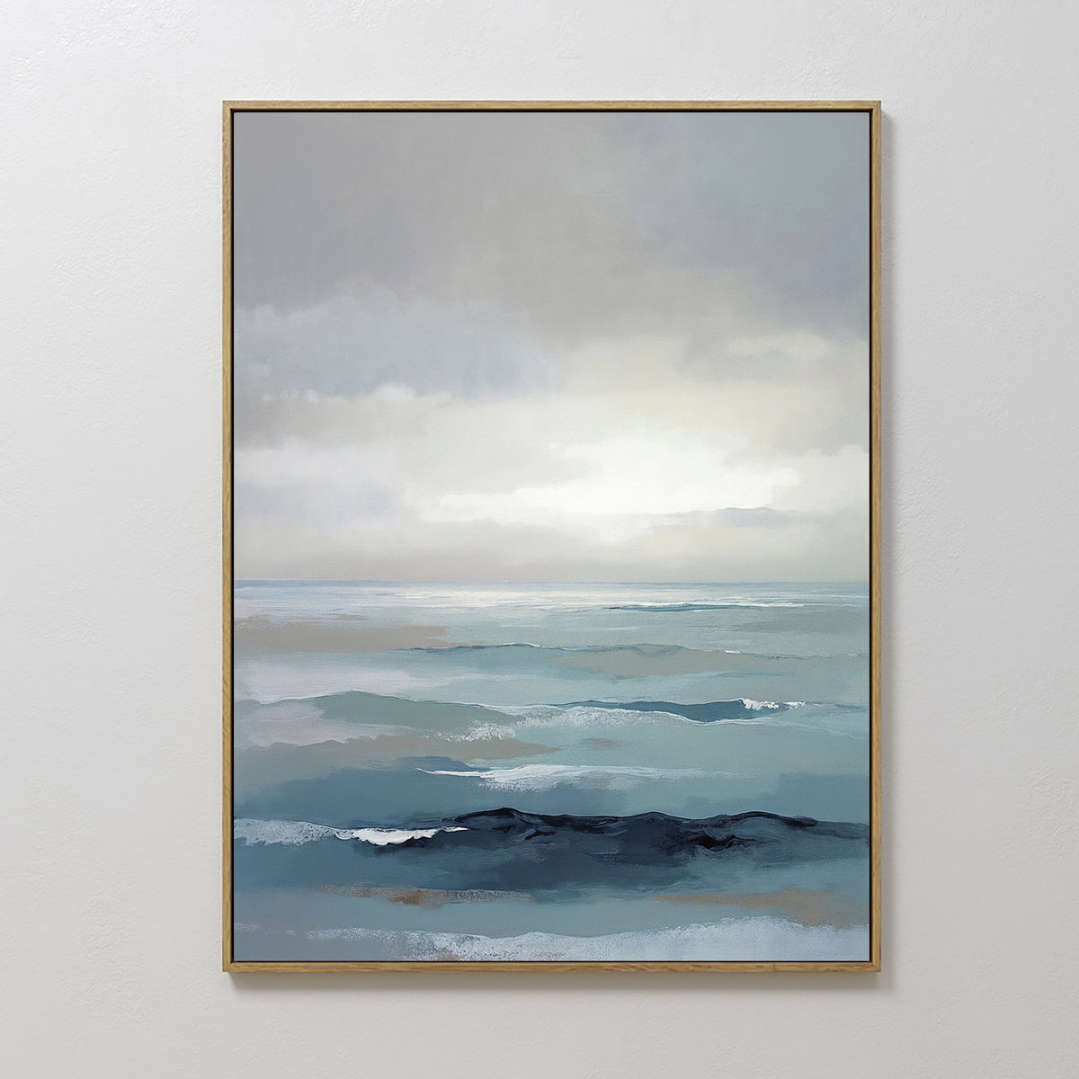 Ocean Swells Canvas Art - Vertical features a tranquil seascape with layered blues, soft waves, and a cloudy sky. This framed wall art brings a peaceful vibe to any Nordic Park-inspired space.