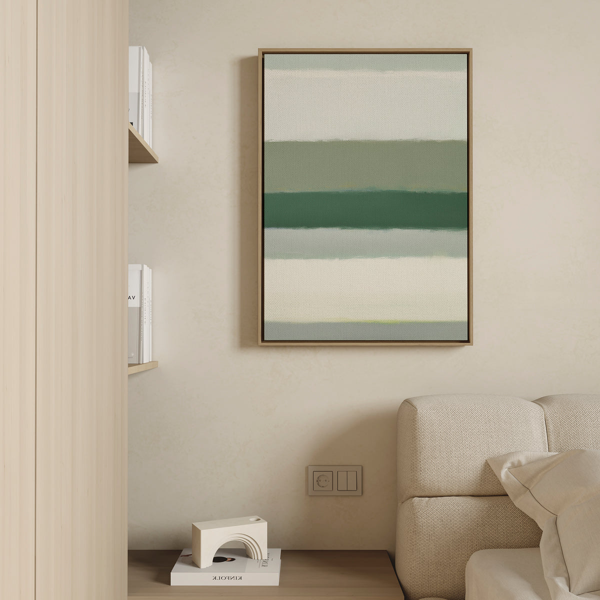 A modern, minimal living space with a beige sofa, light wooden shelves for books, and Sage Gradient Canvas Art - Vertical—a calming abstract piece with green and white stripes—displayed on a cream wall.