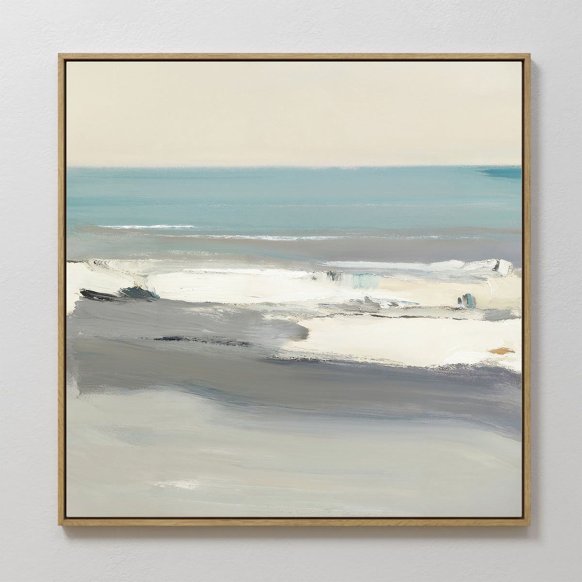 The Sandy Retreat Canvas Art - Square features an abstract seascape in soft blue, white, and gray. Framed in thin gold and displayed on a white wall, it brings subtle coastal vibes to any space.