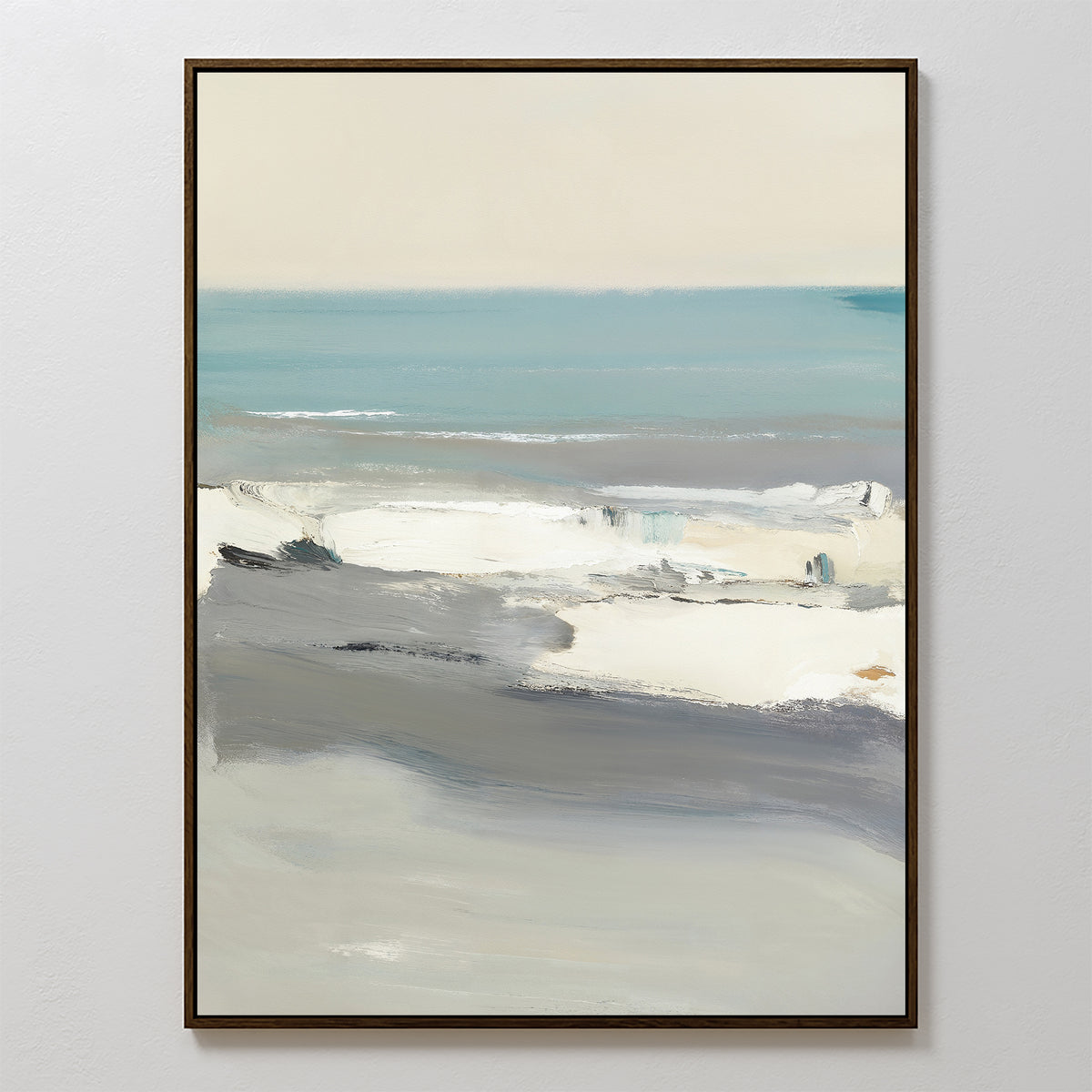 The Sandy Retreat Canvas Art - Vertical depicts a coastal landscape with soft blue, white, and gray tones. Featuring broad, blended brushstrokes suggesting sea and shoreline, this abstract beachscape comes in a thin dark frame.