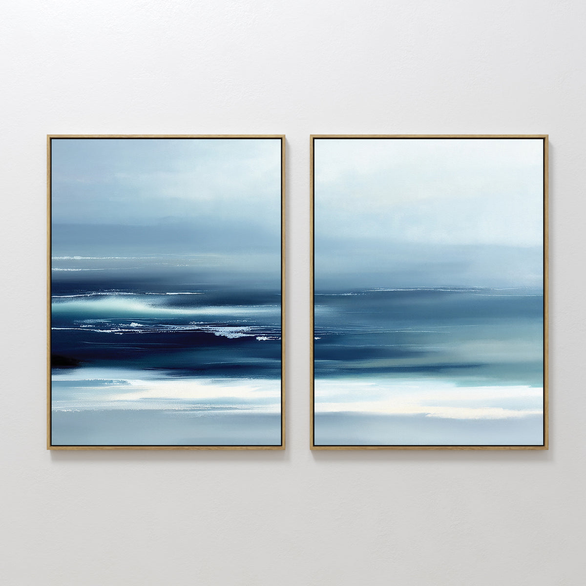 Sapphire Current - Set Of 2 features framed abstract prints with smooth blue and white gradients, evoking a tranquil seascape. Horizontal brushstrokes and soft blending create calming, modern wall art for any space.
