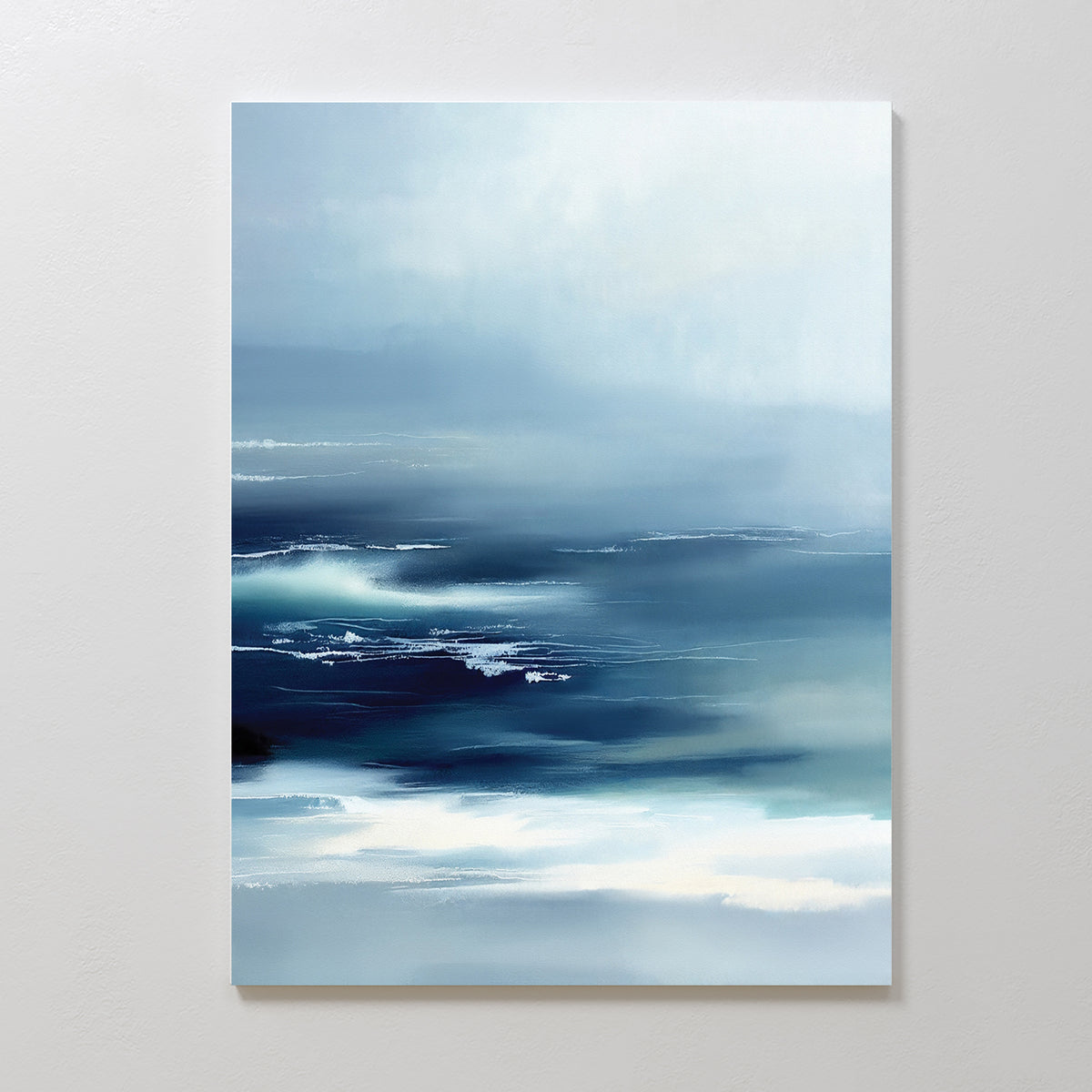 Sapphire Current Canvas Art - Vertical features abstract blue and white waves blending like ocean mist, creating a tranquil and serene wall art effect on any light-colored wall.