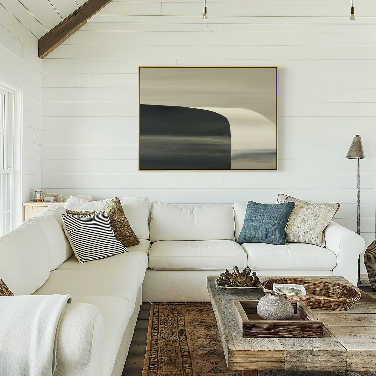A bright, cozy living room features a white sectional sofa, assorted throw pillows, rustic wooden coffee table, and the Sculptural Forms Canvas Art - Horizontal on a white shiplap wall, adding minimalist decor and a modern inviting touch.