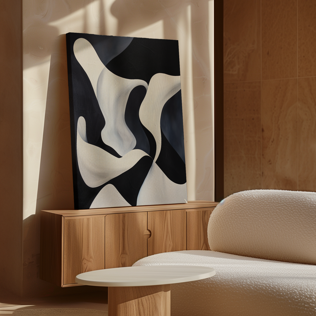 The Deep Blue Calm Abstract Canvas Art sits on a wooden sideboard in a bright, modern room with a textured white sofa and round table, making it perfect for enhancing your living room decor.