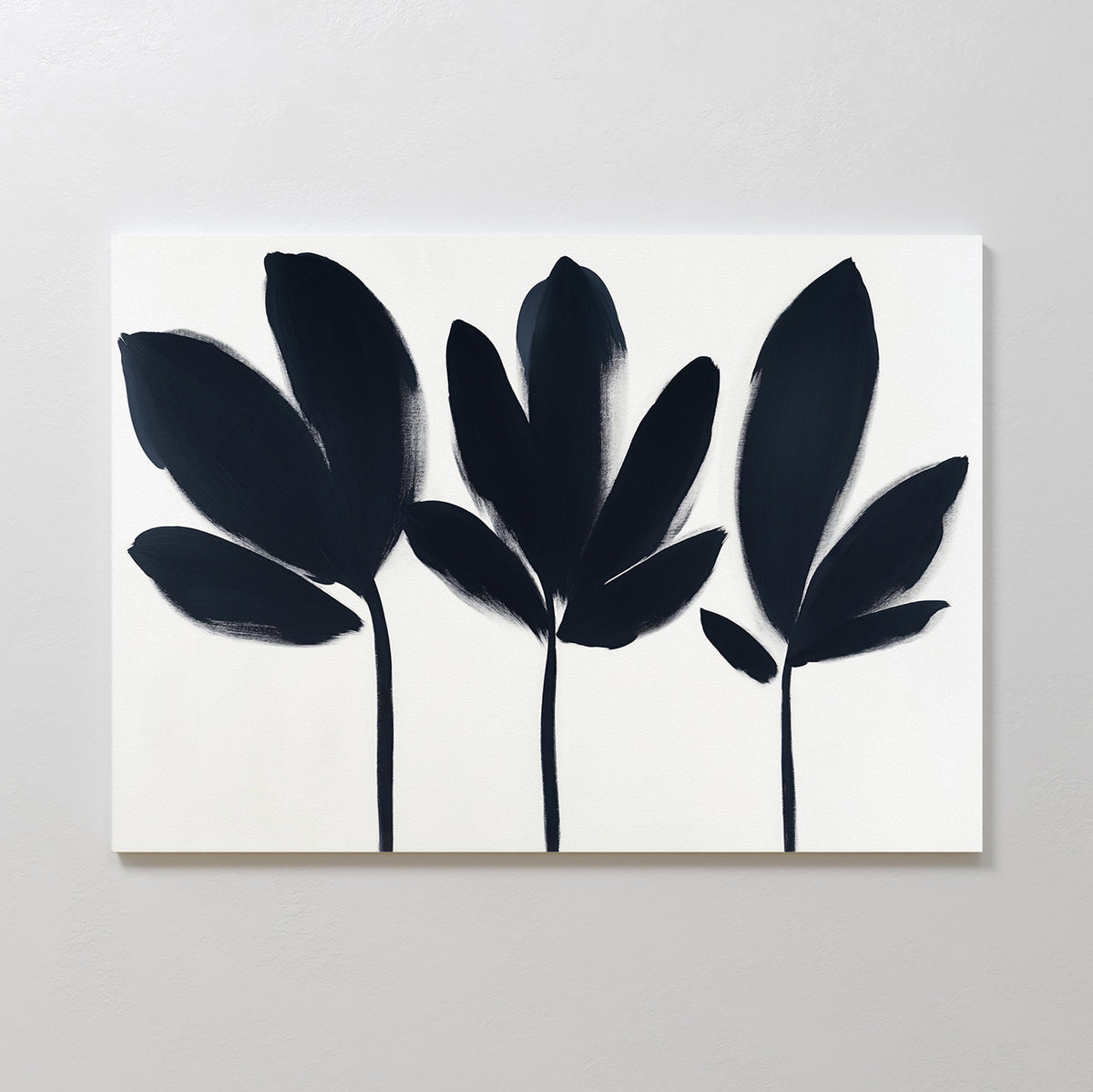 Shadow Stems Canvas Art - Horizontal showcases three unique black botanical silhouettes with stems on a white canvas, offering a bold yet minimalist touch—ideal for modern living rooms.