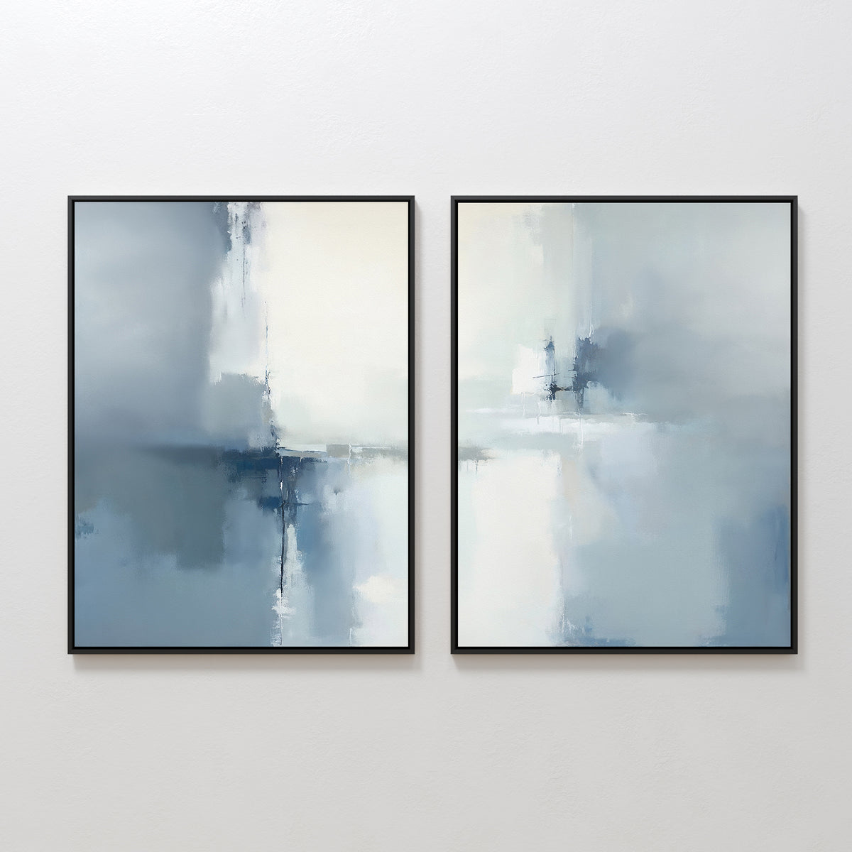 The Silver Cross Formation - Set Of 2 features abstract art in soft blue, white, and gray tones with blurred brushstrokes and thin black frames, adding a calm, serene vibe to modern living rooms.