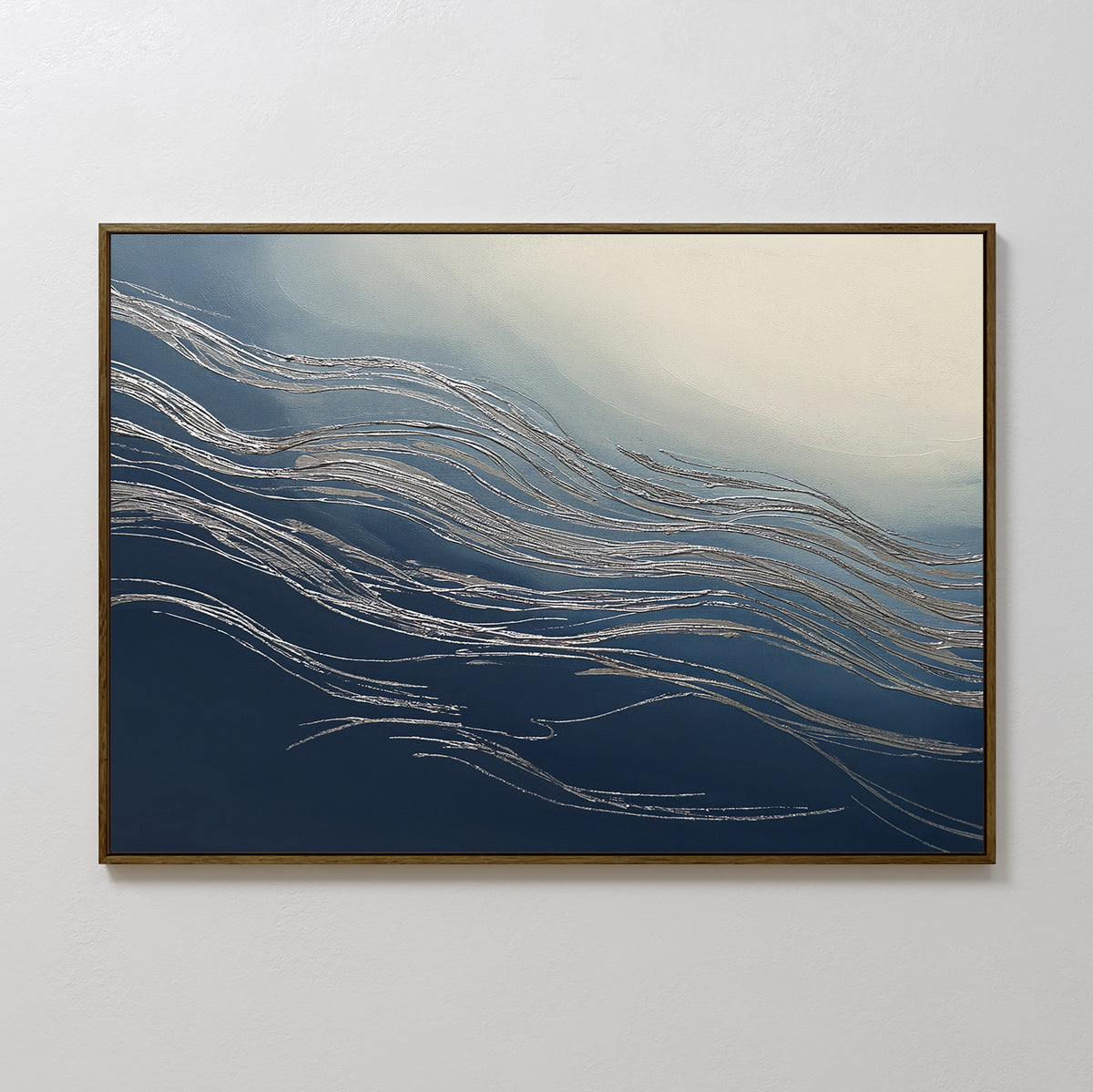 Silver Current Canvas Art - Horizontal showcases flowing metallic silver ribbons on a gradient background from deep navy to light cream, evoking wave-like movement. Framed with a slim dark border and displayed on a plain white wall.