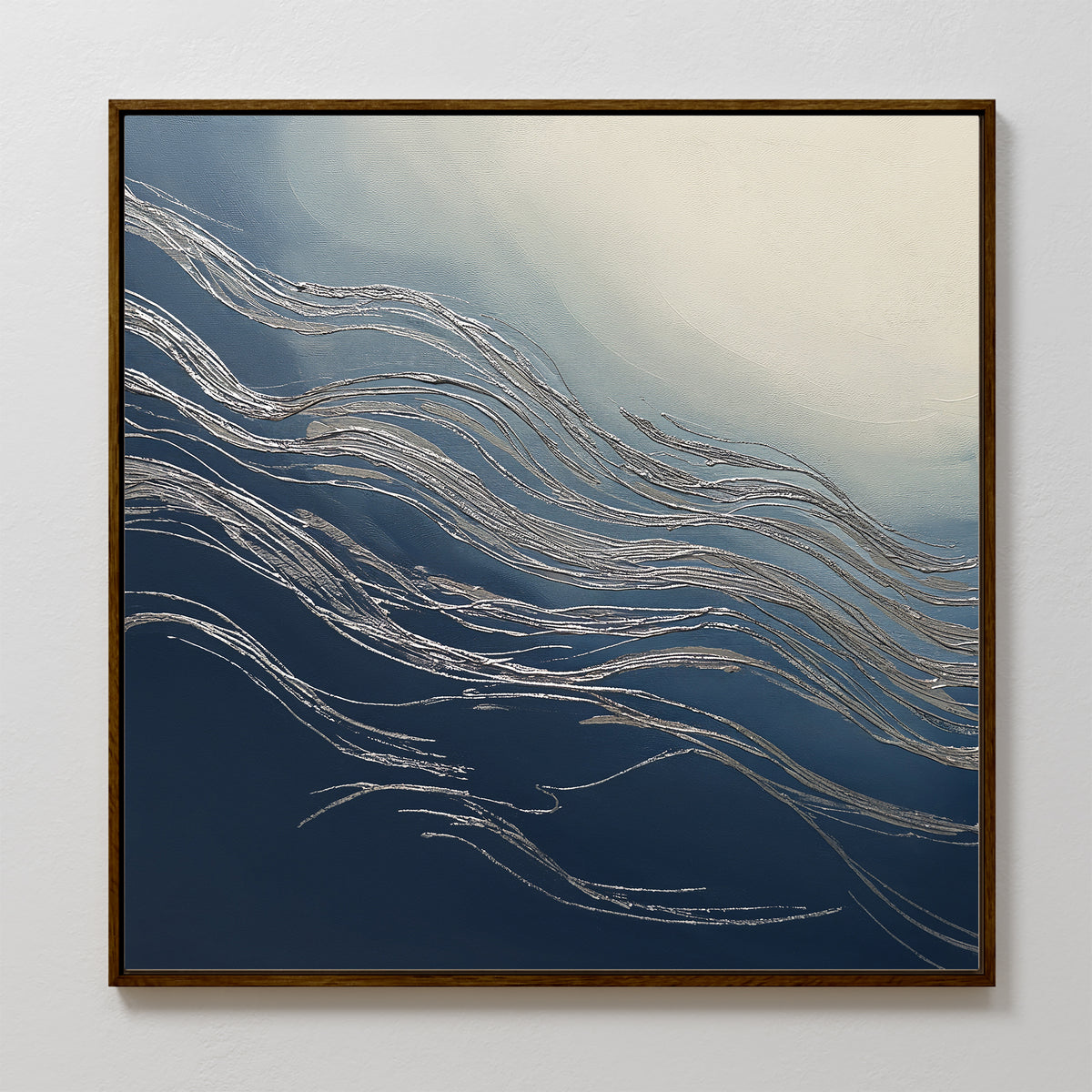 The Silver Current Canvas Art - Square features silver wavy lines over a blue and white gradient, evoking water or wind movement. Framed in thin dark wood, it brings contemporary sophistication to any light-colored wall.