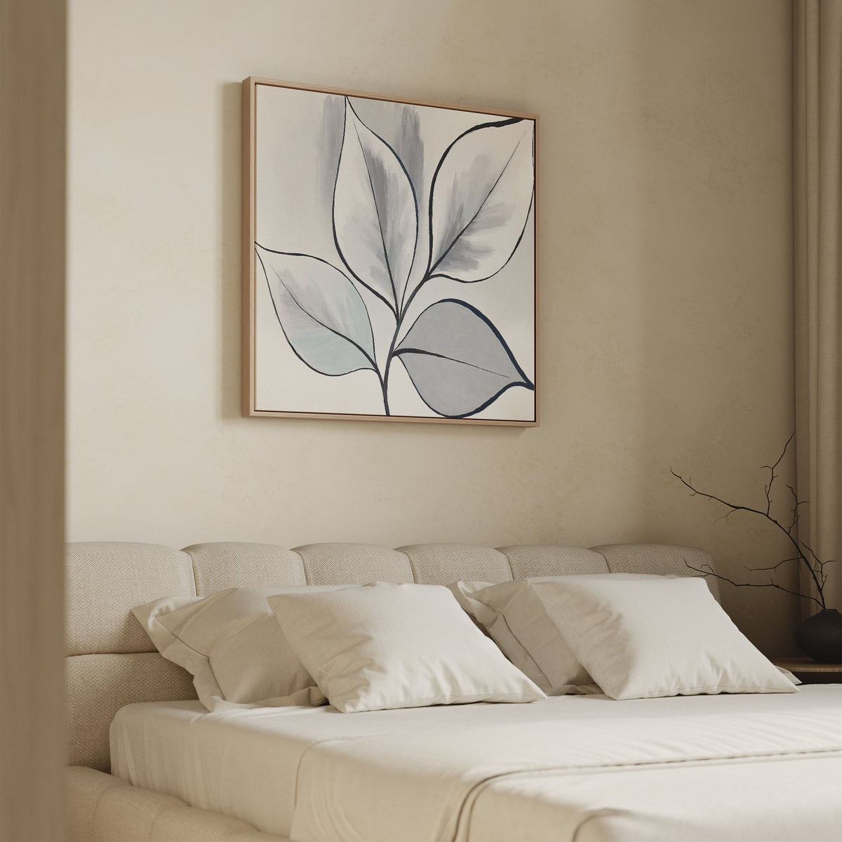 A minimal bedroom features a beige upholstered bed with white bedding and four pillows. Above the bed hangs the Silver Leaves Canvas Art - Square, while soft lighting and neutral tones create a calm, serene space for modern home decor.