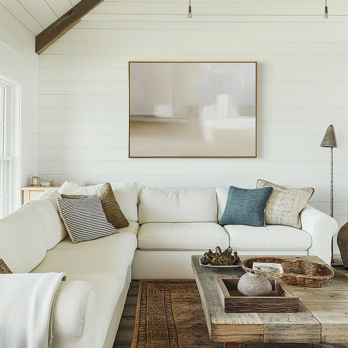 A bright, cozy living room with white shiplap walls, a white sectional with textured pillows, a rustic wooden coffee table, and the Soft Layers Canvas Art - Horizontal on the wall. Neutral tones and natural light create an inviting feel.