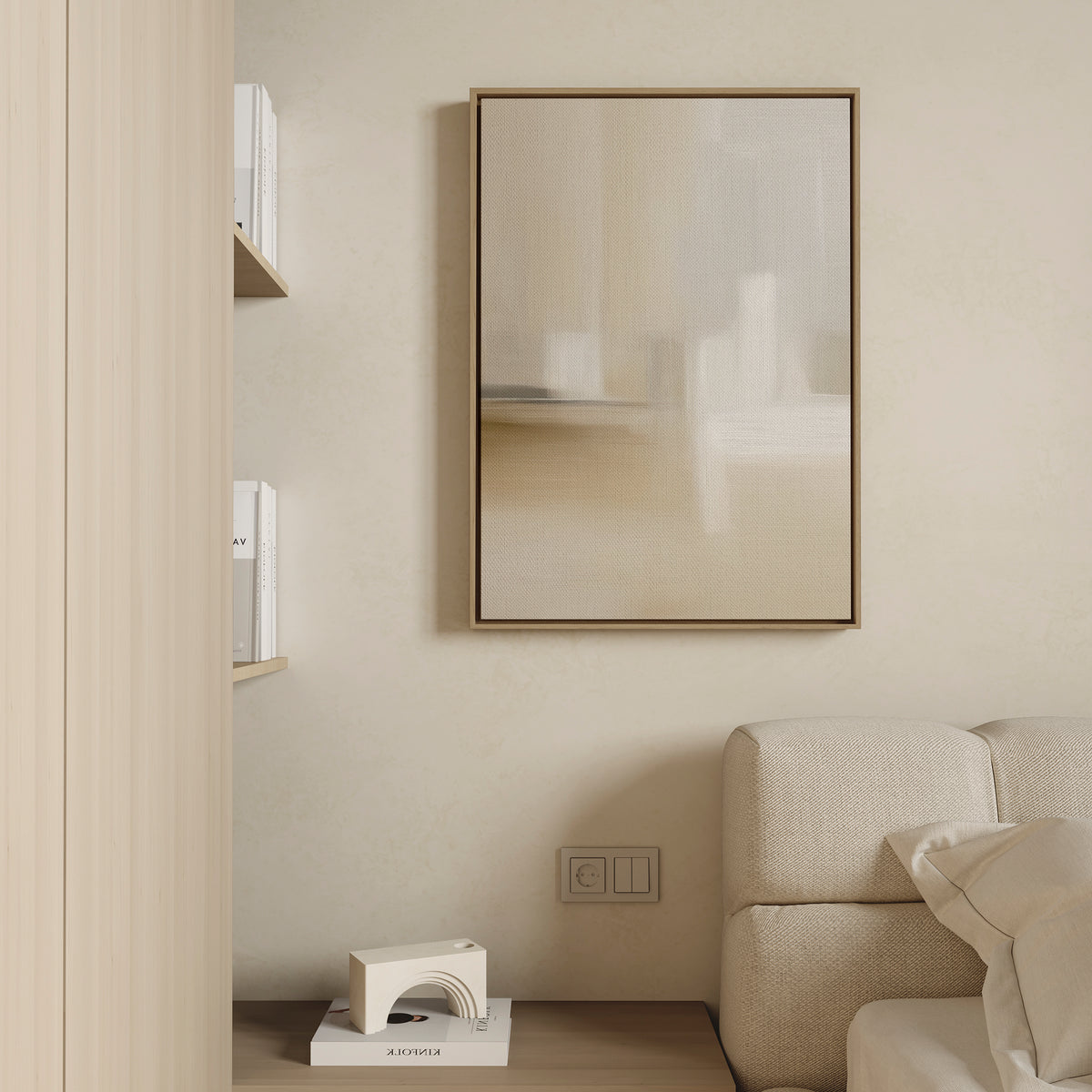Minimalist living room corner with a beige sofa, Soft Layers Canvas Art - Vertical as neutral wall art, floating shelves holding books, and a small geometric decorative object on the floor. Neutral tones create a serene atmosphere.