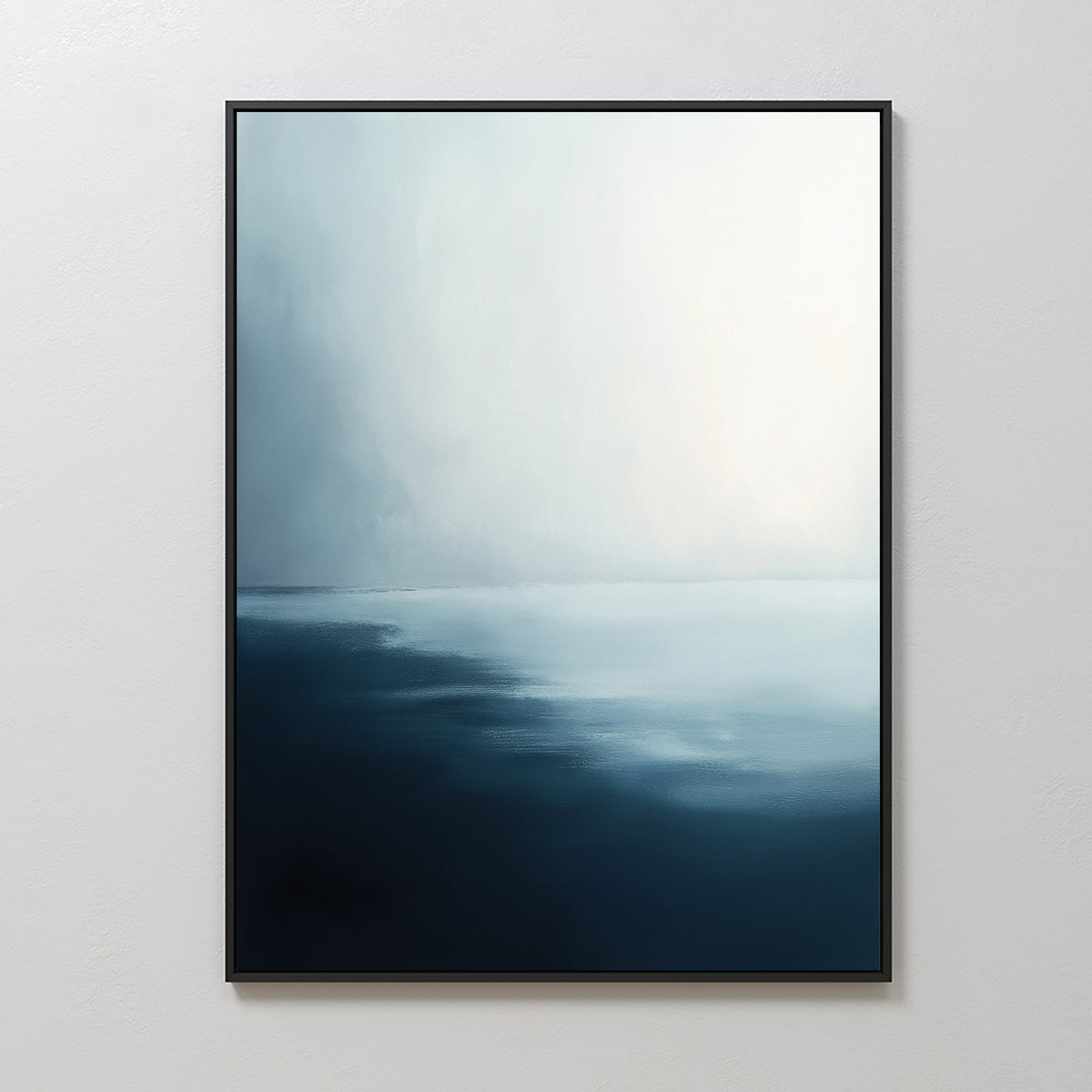 The Steel Harbor Mist Canvas Art - Vertical features a gradient from deep navy to soft white, evoking a calm seascape. Framed on a plain white wall, it adds serene elegance and minimalist style to any living room.