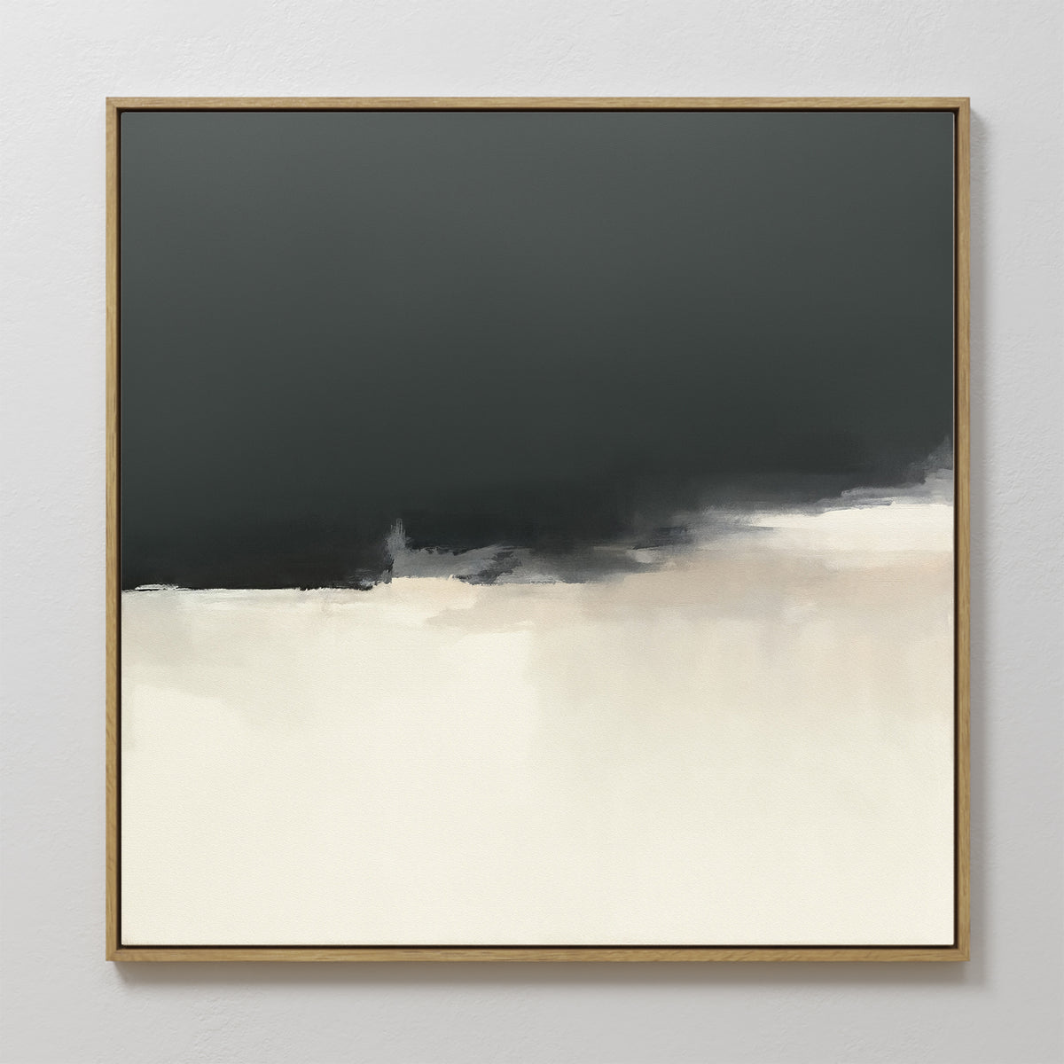 The Tempest Brewing Canvas Art - Square features a minimalist abstract design with a dark upper section blending into white and light beige below, colors merging softly at the center. This atmospheric wall art comes framed in thin, light wood.
