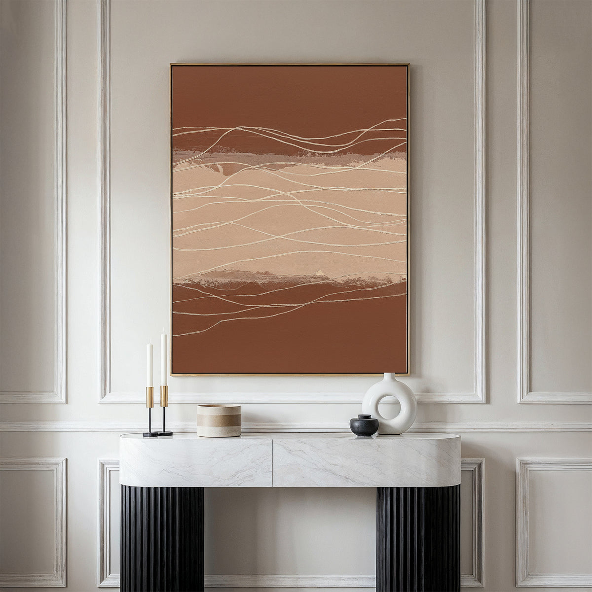 A modern entryway features a white marble console table, minimalist decor, and the Terracotta Currents Canvas Art - Vertical with wavy lines and earth tones on a paneled wall.
