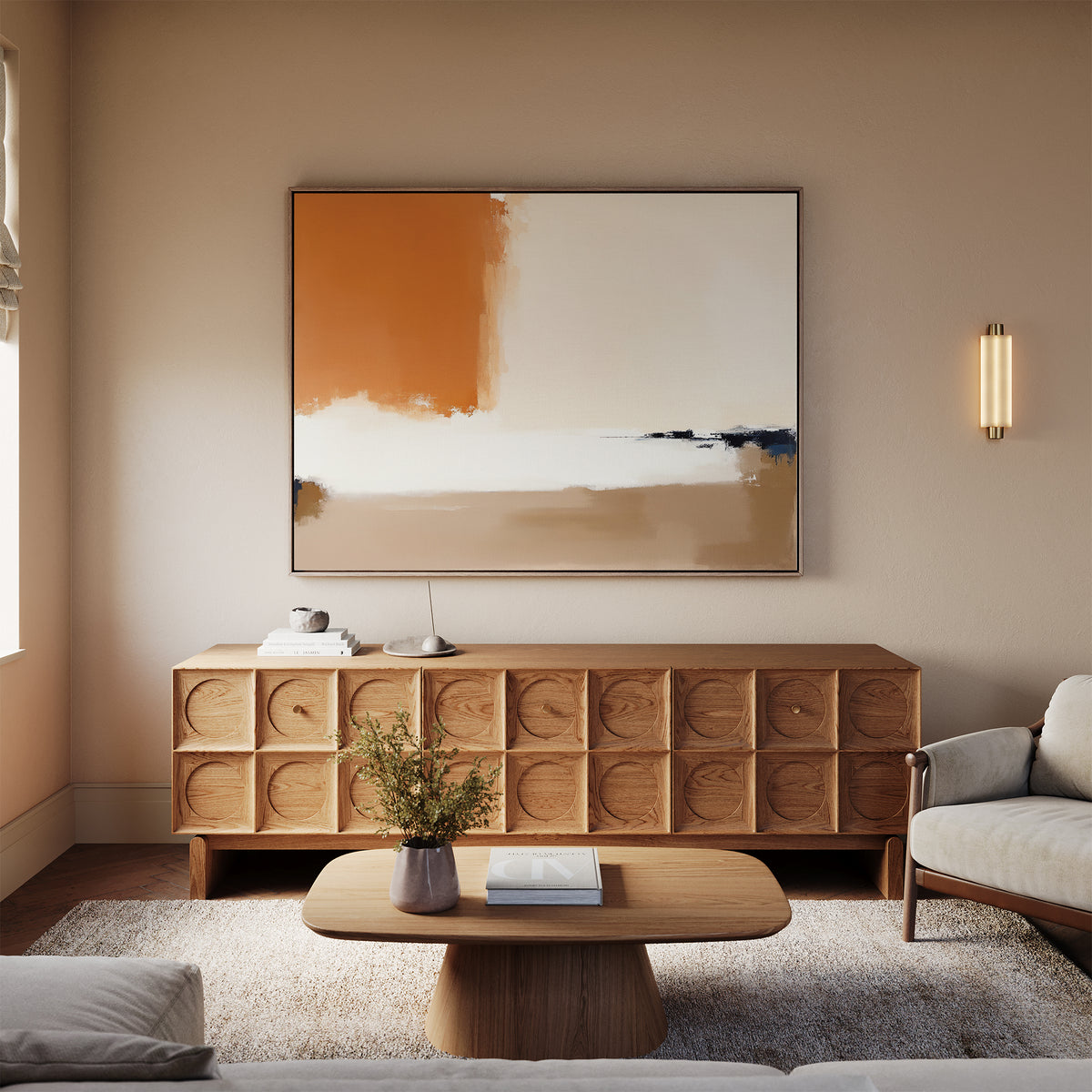 A modern living room featuring a wooden sideboard, the Terracotta Edge Canvas Art - Horizontal above it, a round wooden coffee table with a book and vase, neutral furniture, and warm lighting for inviting decor.