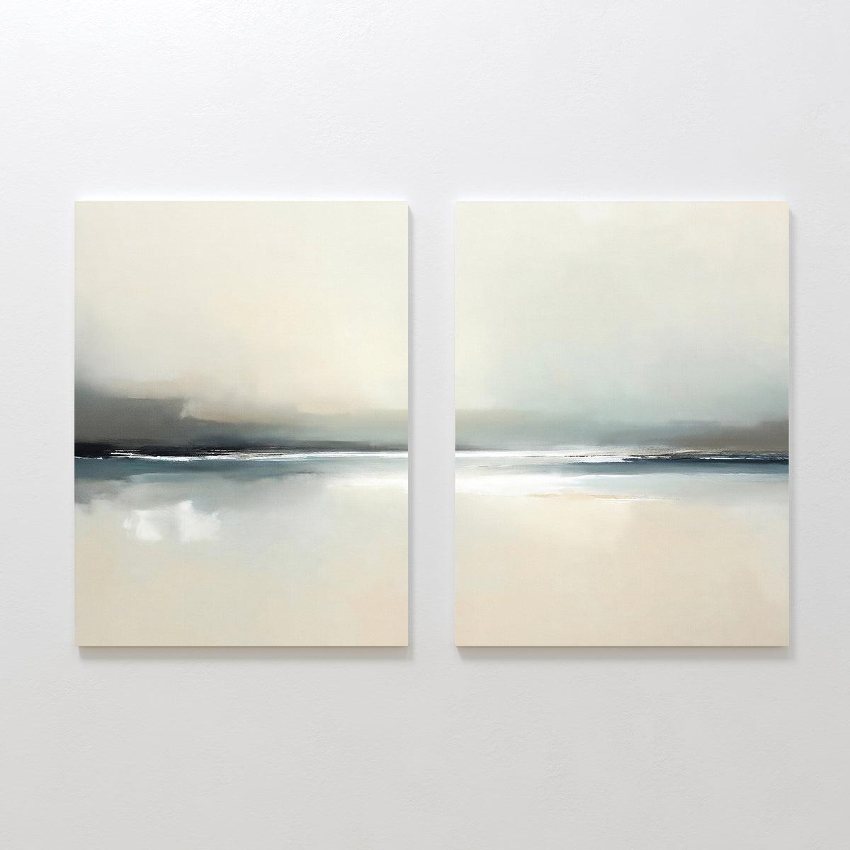 The "Veiled Estuary - Set Of 2" features minimalist abstract paintings in muted beige, white, gray, and blue tones, capturing a serene landscape reminiscent of a tranquil Nordic park with subtle horizons over reflective water or sand.