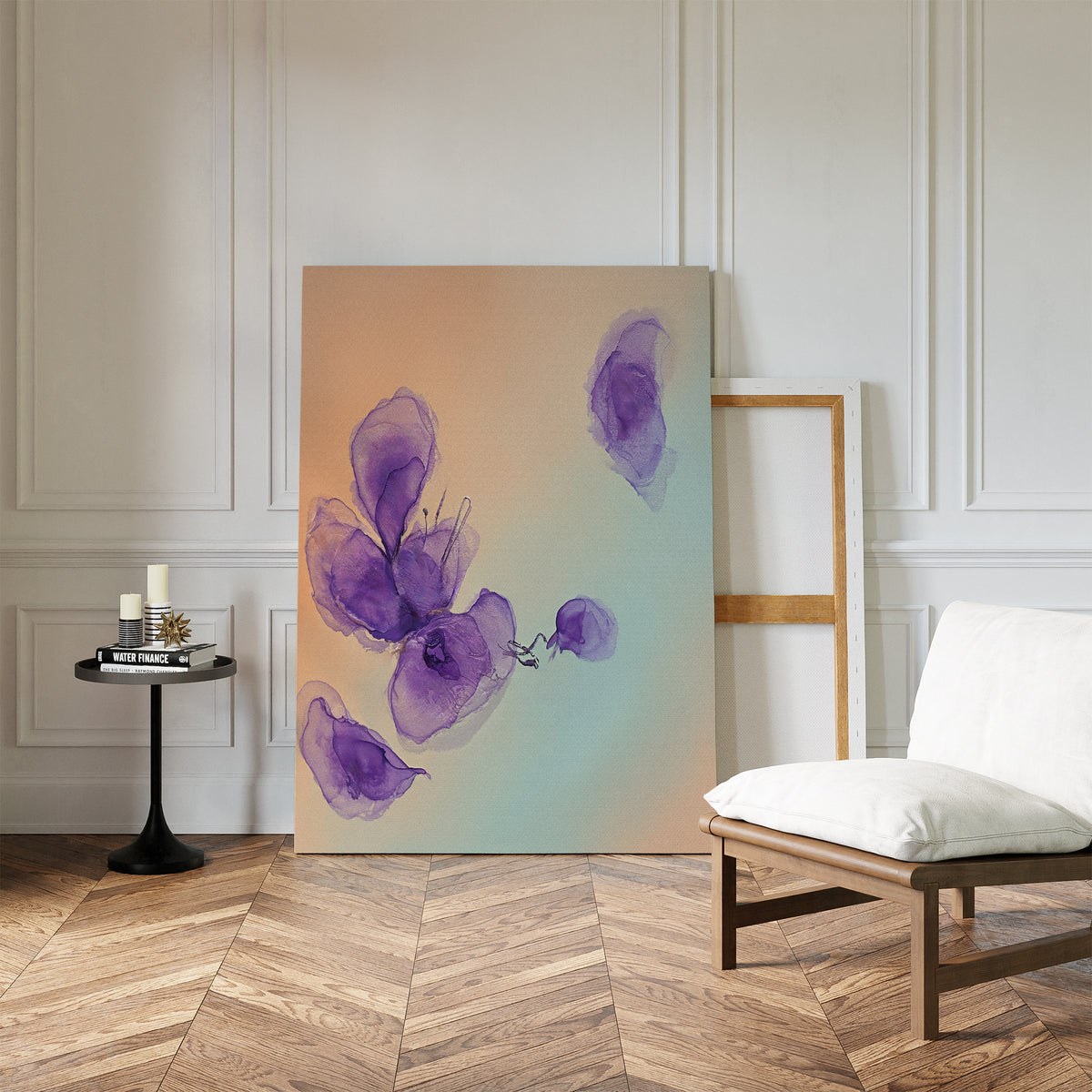 The Violet Dreams Canvas Art - Vertical leans against a white paneled wall in a minimalist room with wooden herringbone floors, a cushioned chair, and a small black table decorated with candles and books.