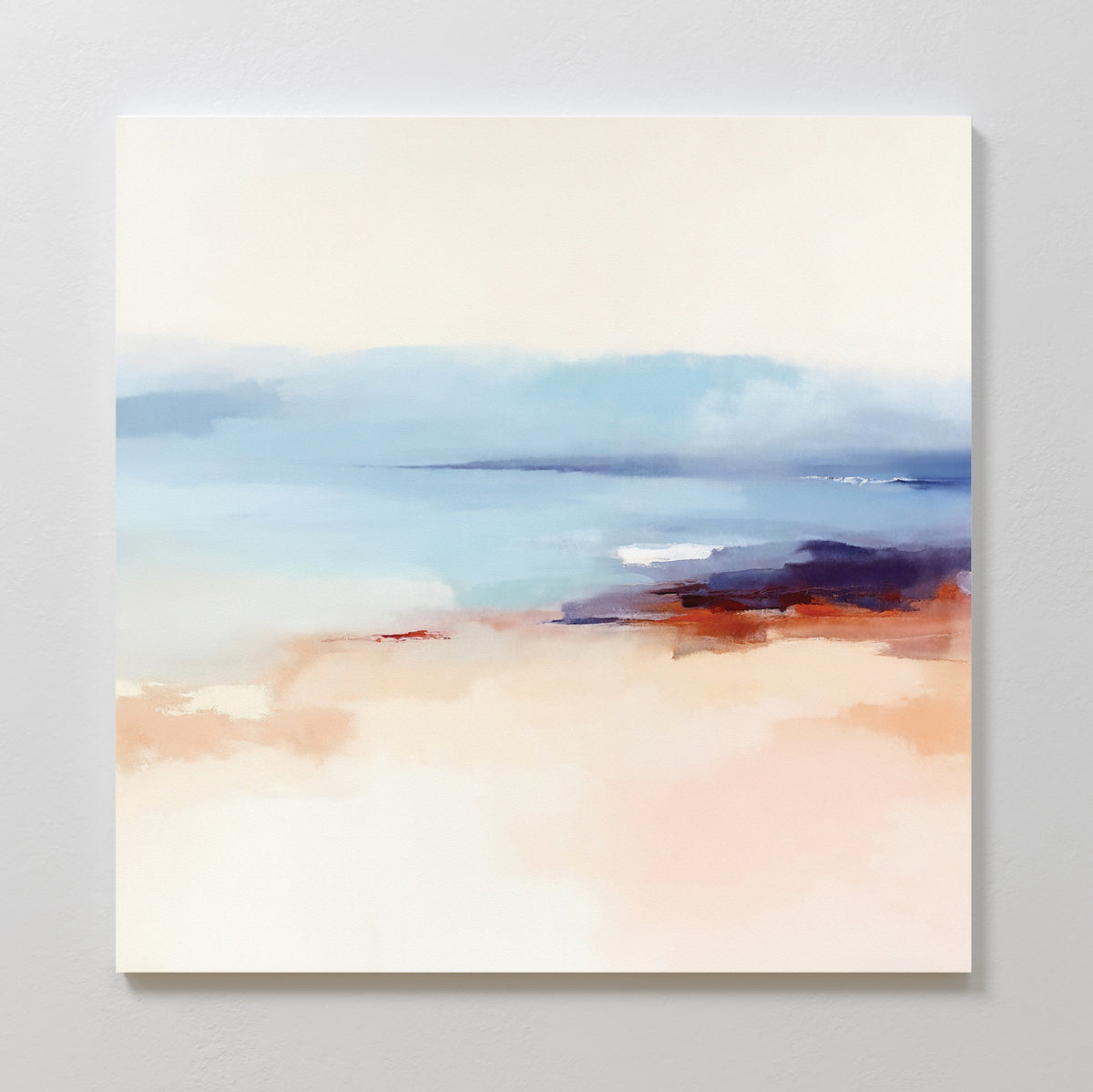Windswept Coastline Canvas Art - Square features a tranquil beach scene in soft pastel colors with sandy beige, sky and water blues, and touches of dark purple and red along the shoreline for a serene coastal look.