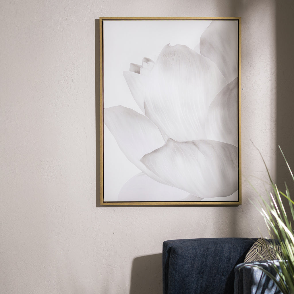 The White Blossom Abstract Canvas Art hangs on a light wall above a dark blue couch, with sunlight casting soft shadows and a green plant in the corner, bringing minimalist elegance to the living room decor.