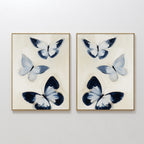 The Midnight Wings Set of 2 features framed wall art with abstract blue and white butterflies on light beige backgrounds, making stylish modern decor to elevate any room.