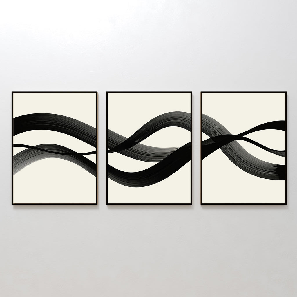 The Fluid Curves Set of 3 features framed abstract prints with black brushstrokes flowing across creamy backgrounds, forming a wavy, interconnected design—ideal as modern wall art to enhance your space.