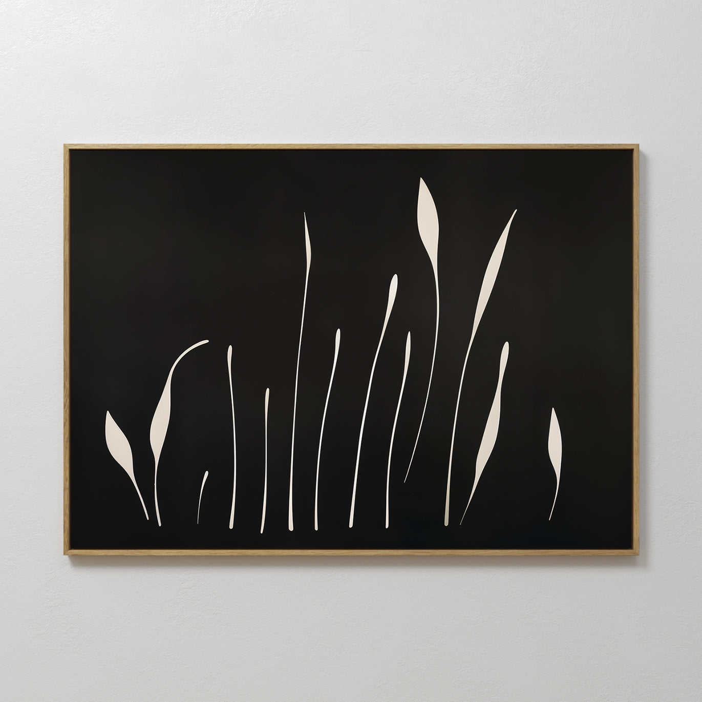 Botanical Silhouettes Abstract Canvas Art features minimalist cream plant shapes on a black background, set in a light wood frame and displayed on a white wall.