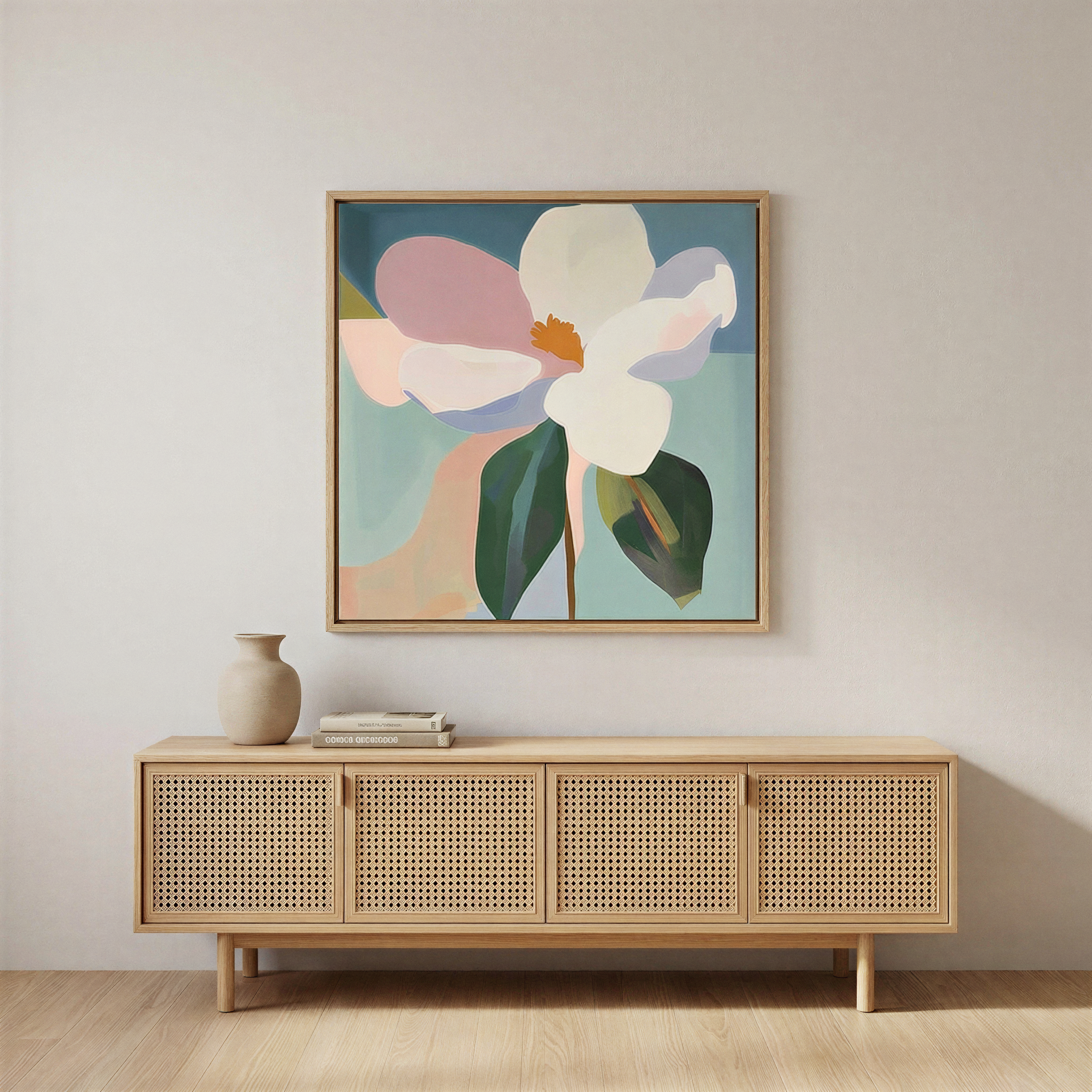 A minimalist room featuring a rattan sideboard with books and a ceramic vase, highlighted by modern elegance from the Bold Bloom Canvas Art, a large, colorful floral wall art set against a plain light wall.