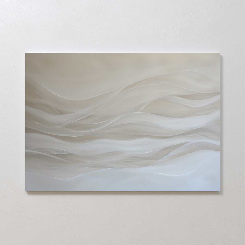 The Sandy Hues Abstract Canvas Art features soft, wavy lines in white and beige on a neutral background. Mounted on a plain white wall, this minimalist piece brings movement and calm, making it ideal for modern living room decor.
