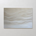 The Sandy Hues Abstract Canvas Art features soft, wavy lines in white and beige on a neutral background. Mounted on a plain white wall, this minimalist piece brings movement and calm, making it ideal for modern living room decor.