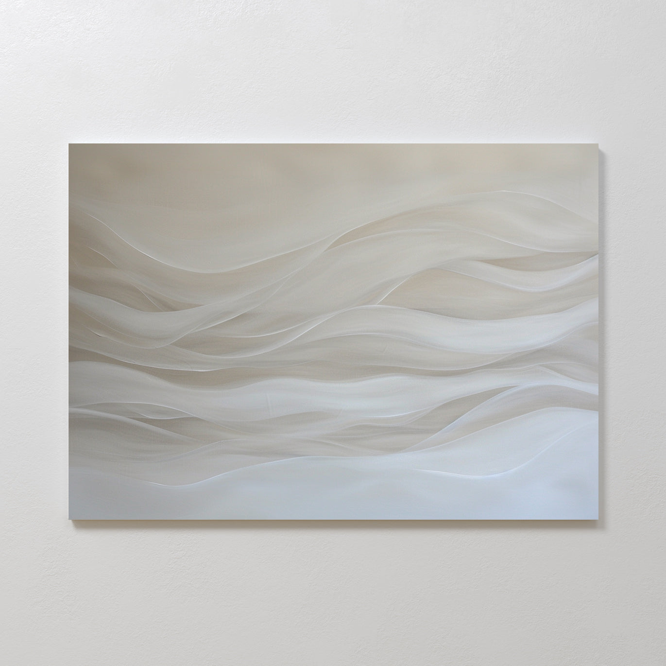 The Sandy Hues Abstract Canvas Art features soft, wavy lines in white and beige on a neutral background. Mounted on a plain white wall, this minimalist piece brings movement and calm, making it ideal for modern living room decor.