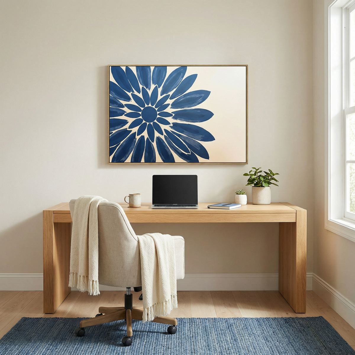 A minimalist home office with a wooden desk, beige chair and light throw, open laptop, coffee mug, plant, and the Azure Radiance Canvas Art - Horizontal on the wall. Natural light enhances the modern living room decor.
