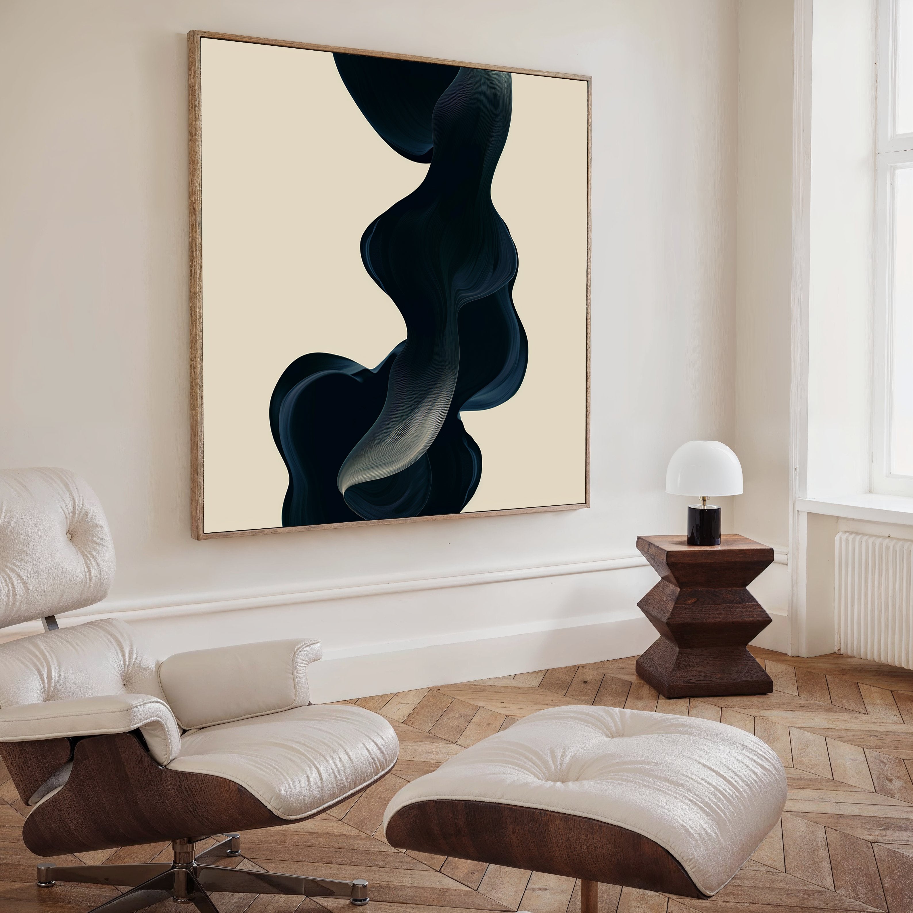 A modern living room features a white leather lounge chair and ottoman, wooden side table with lamp, and Nocturnal Wave Abstract Canvas Art on a beige wall. Light wood floors and large windows complete the stylish decor.