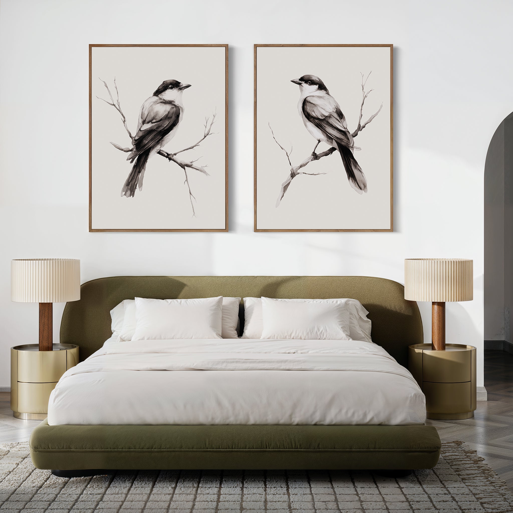 A modern bedroom with a green upholstered bed, neutral bedding, two round nightstands and lamps, plus striking Still Perch Set of 2 bird art prints from Nordic Park displayed above the headboard.