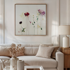 A modern living room features a beige sofa, neutral pillows, a wooden side table with a white lamp, and the Wild Flower Canvas Art hanging above. Dried flowers in a vase decorate the coffee table.