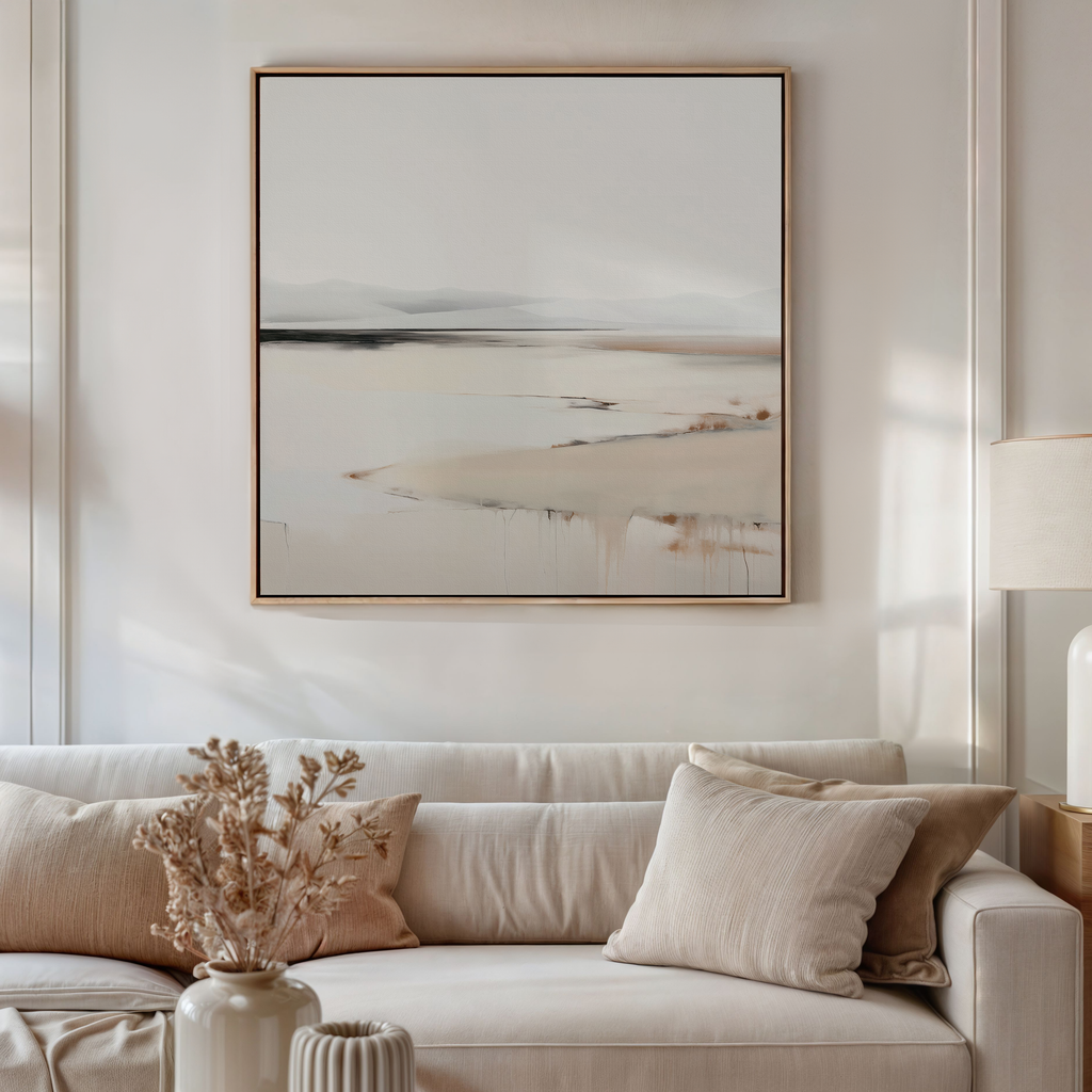 A neutral-toned living room with a beige sofa, cream and tan cushions, a dried flower arrangement in a ceramic vase, and the Quiet Valley Abstract Canvas Art above the sofa enhances the living room decor.